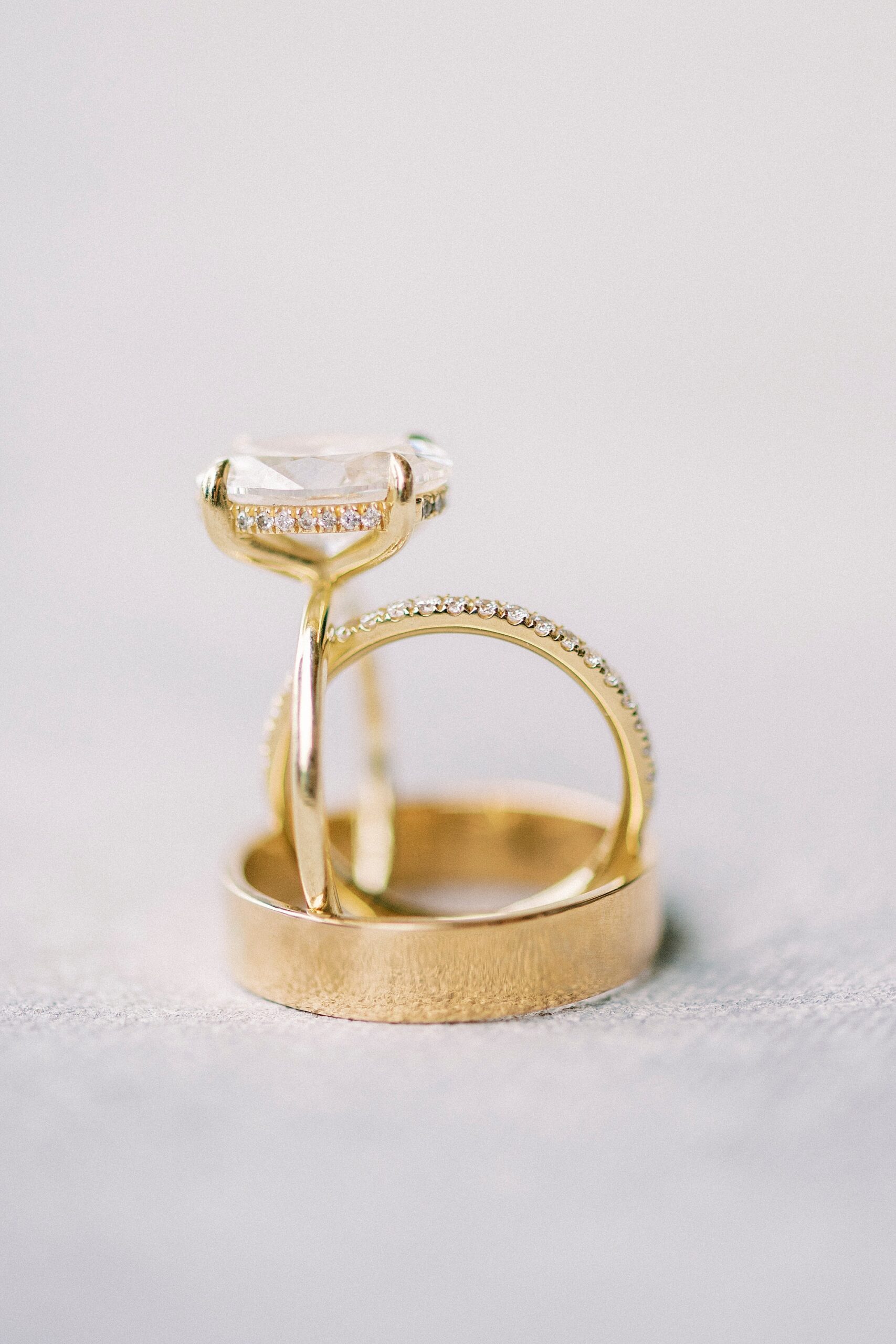 gold wedding bands rest inside man's wedding band