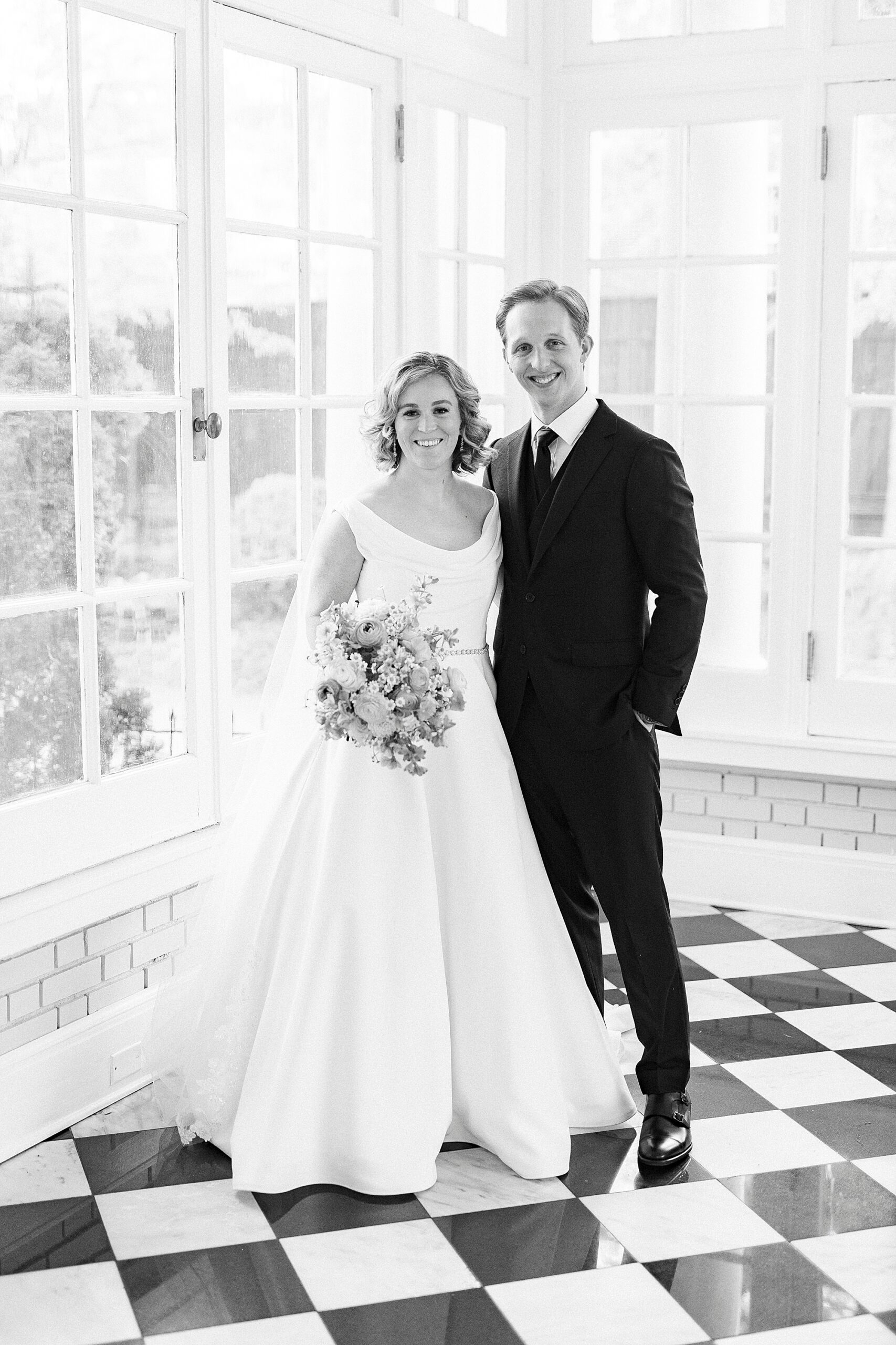 bride and groom hug on checkered floor inside Separk Mansion