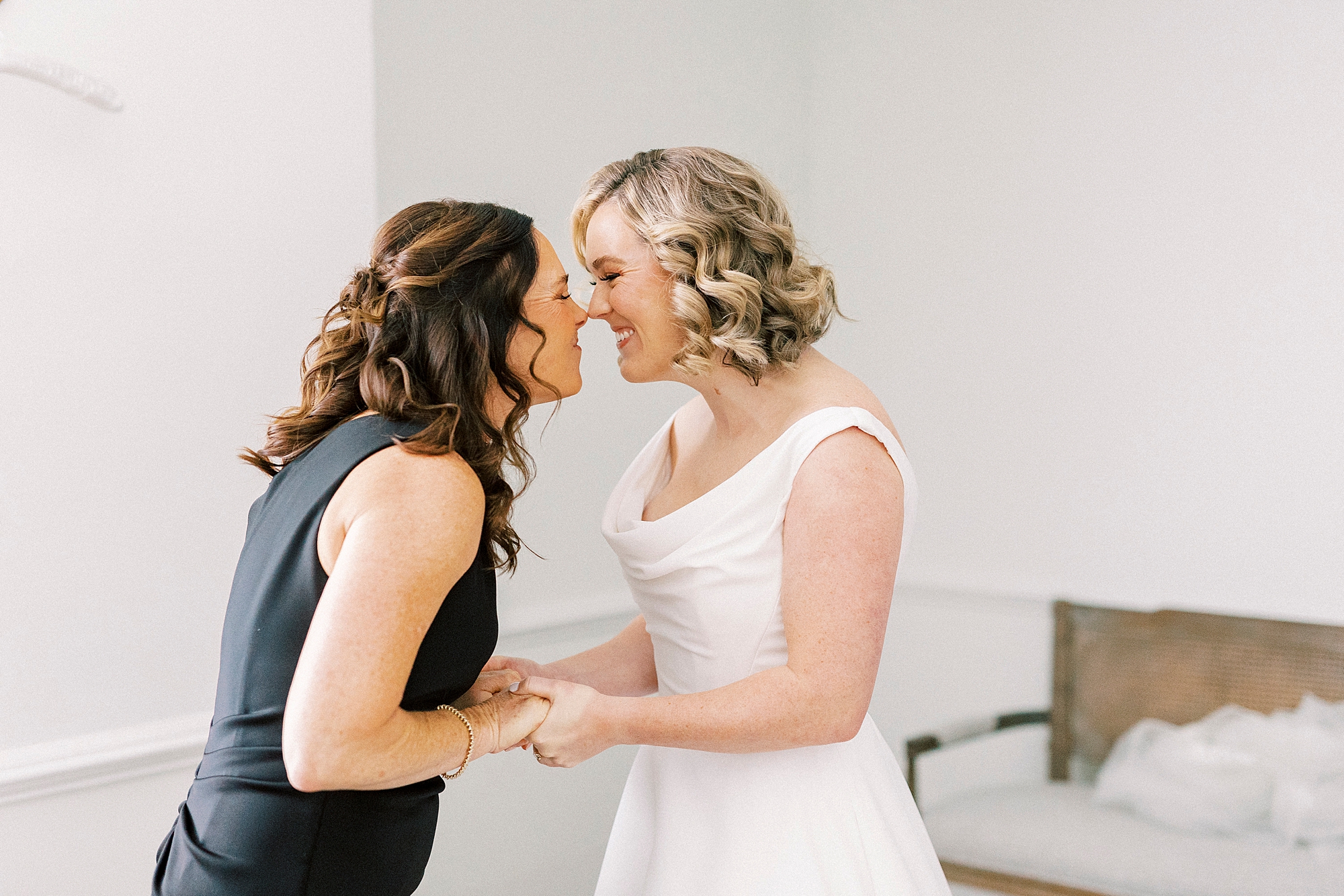 bride and bridesmaid nuzzle noses during prep at Separk Mansion