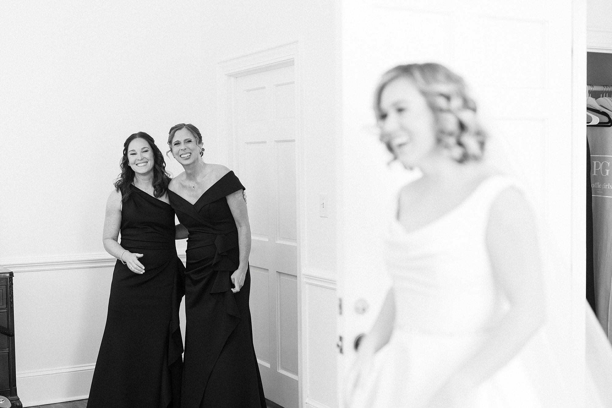bridesmaids look at bride as she walks into suite at Separk Mansion