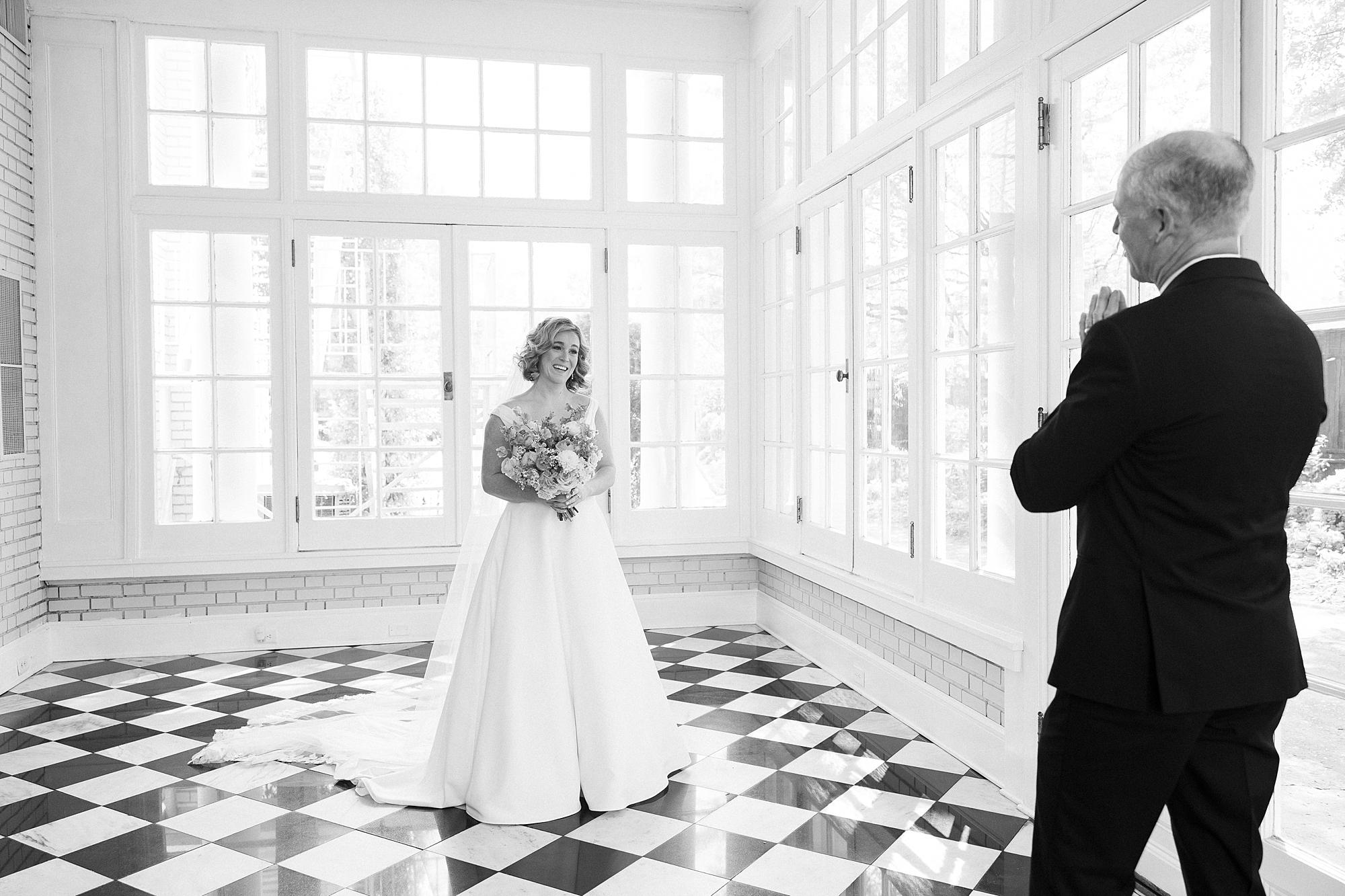 bride and dad have first look in sun room of Separk Mansion