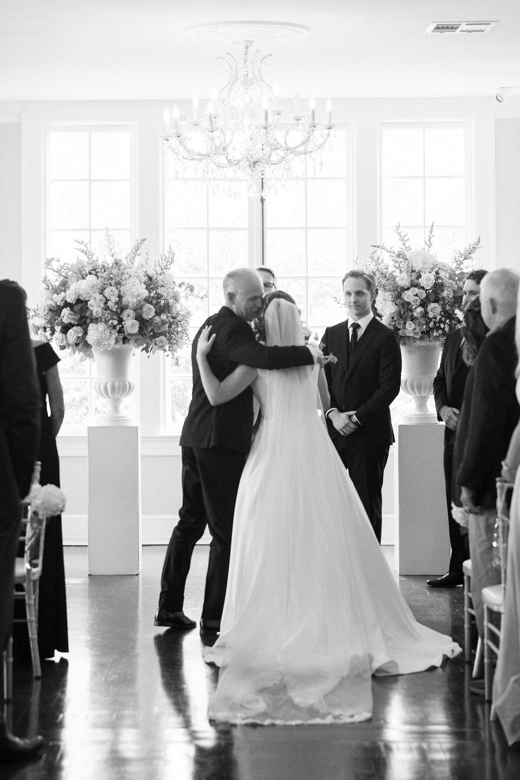 bride hugs father at end of the aisle inside Separk Mansion