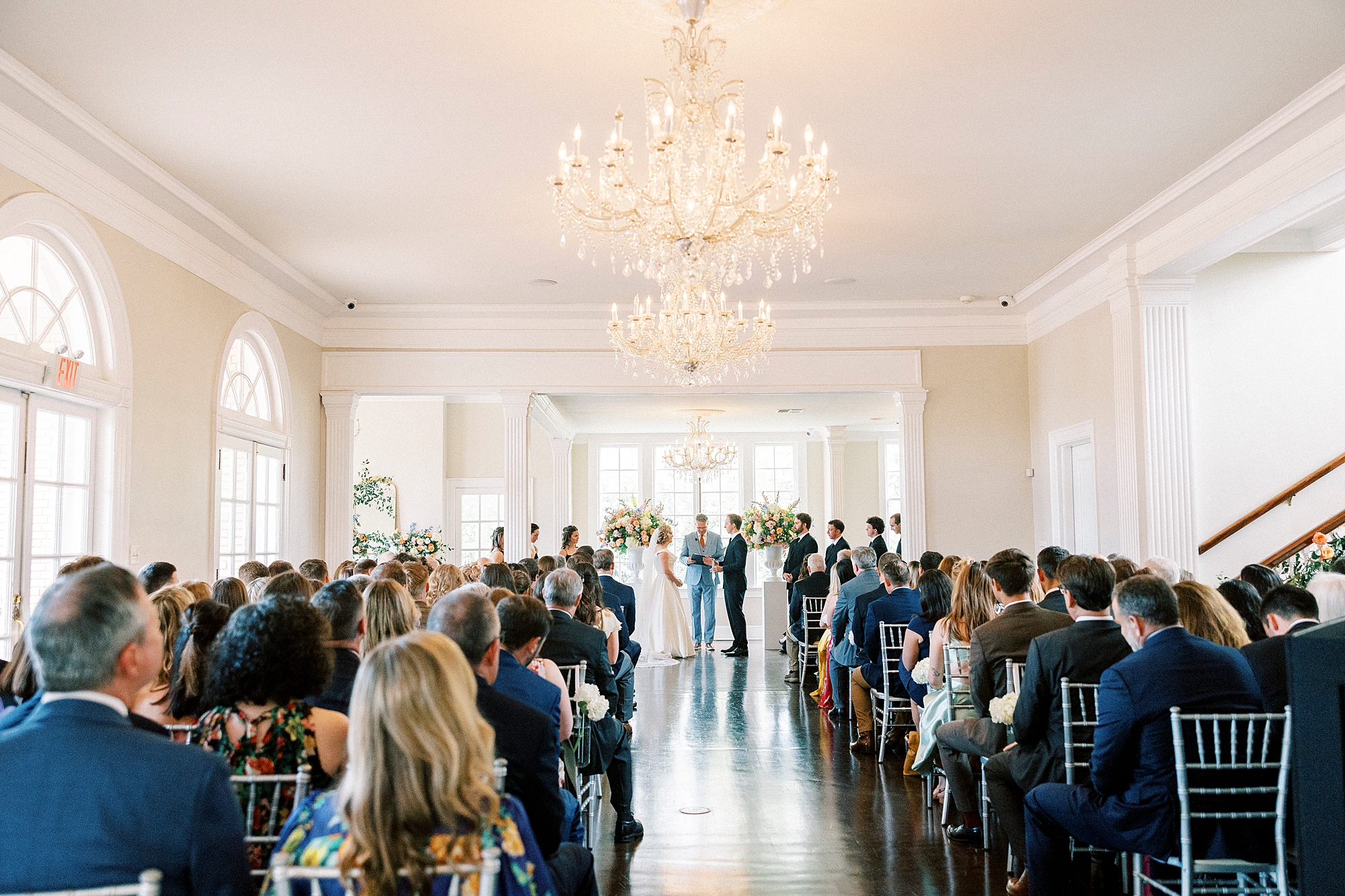 wedding guests watch ceremony inside Separk Mansion