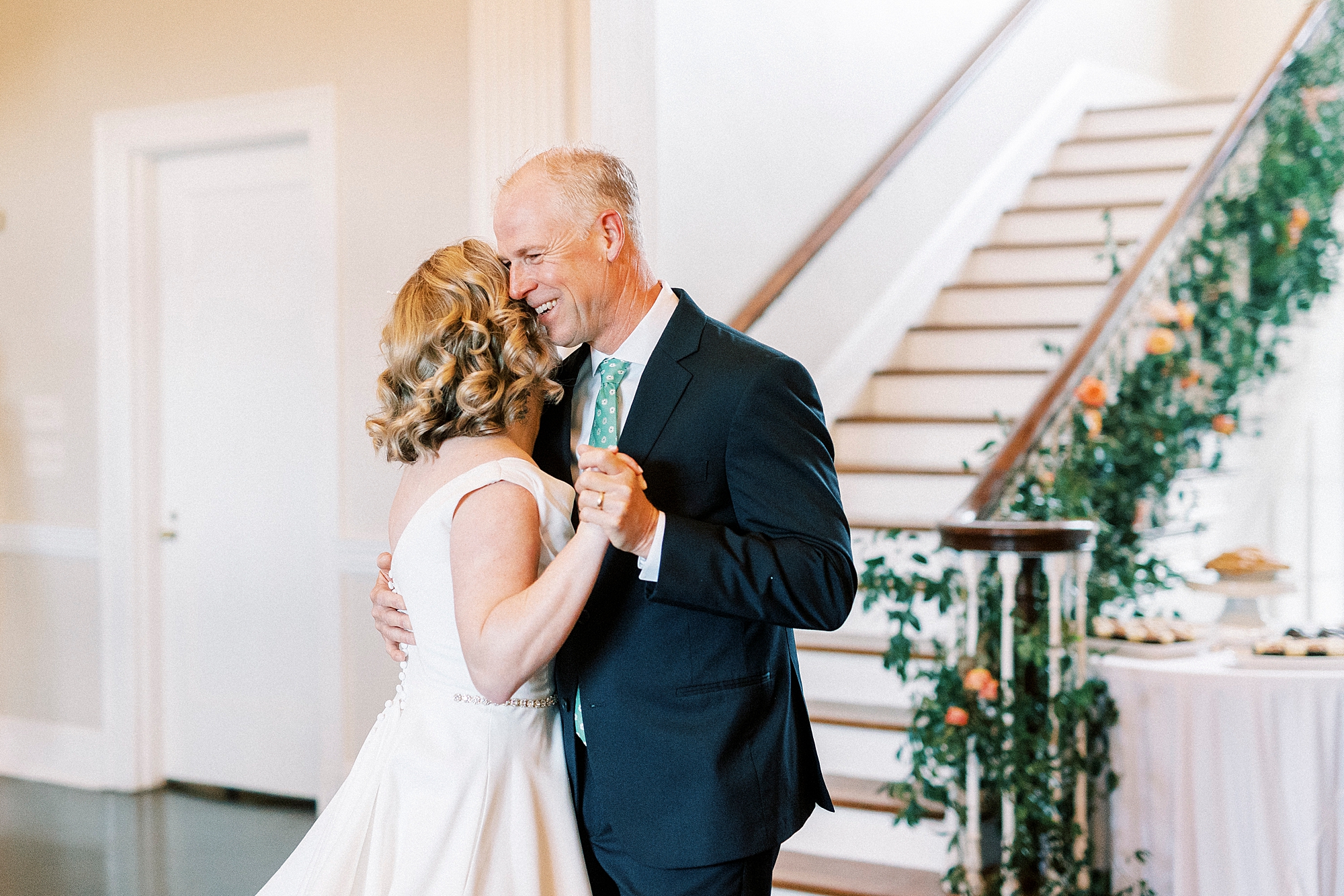 father hugs bride on dance floor during reception at Separk Mansion