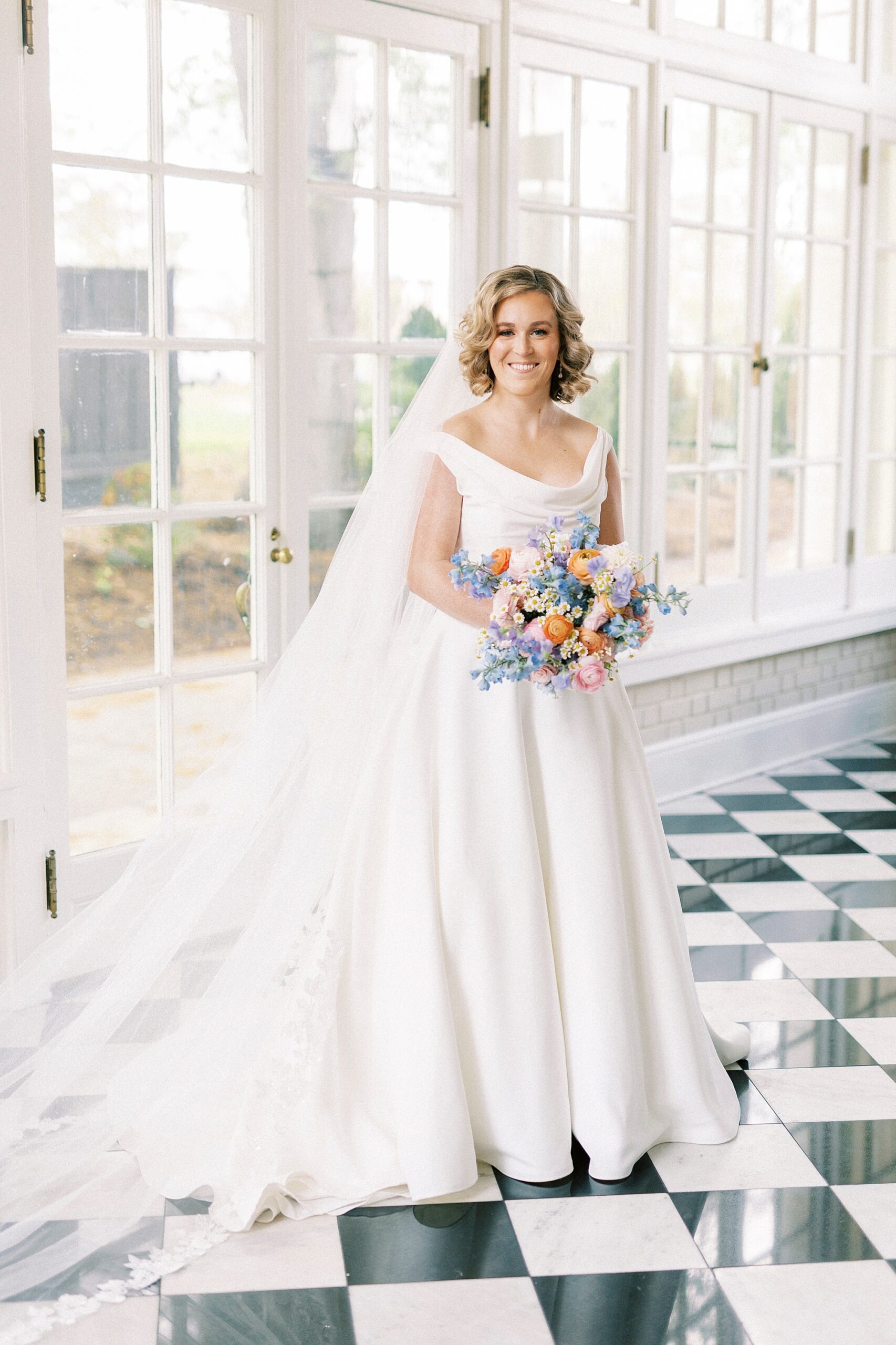 bride poses in sunroom of Separk Mansion