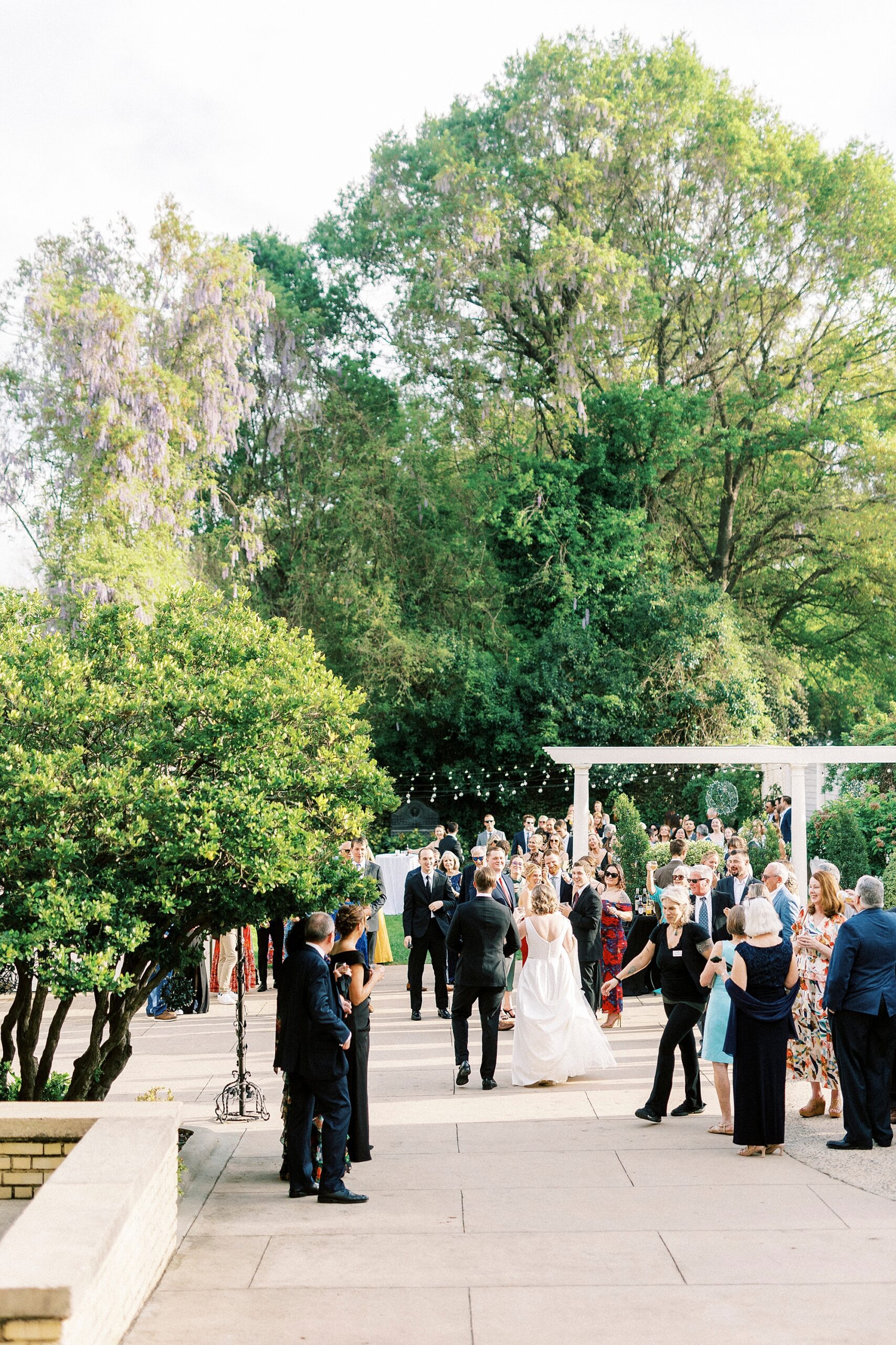 guests mingle with bride and groom on patio at Separk Mansion
