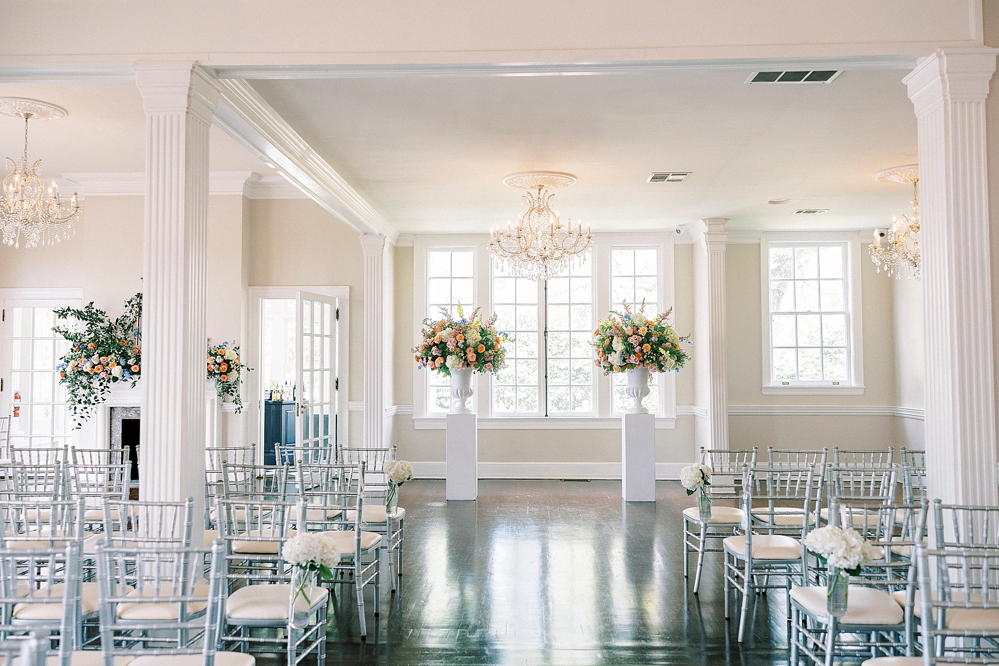 ceremony site inside Separk Mansion with pastel flower arrangements 