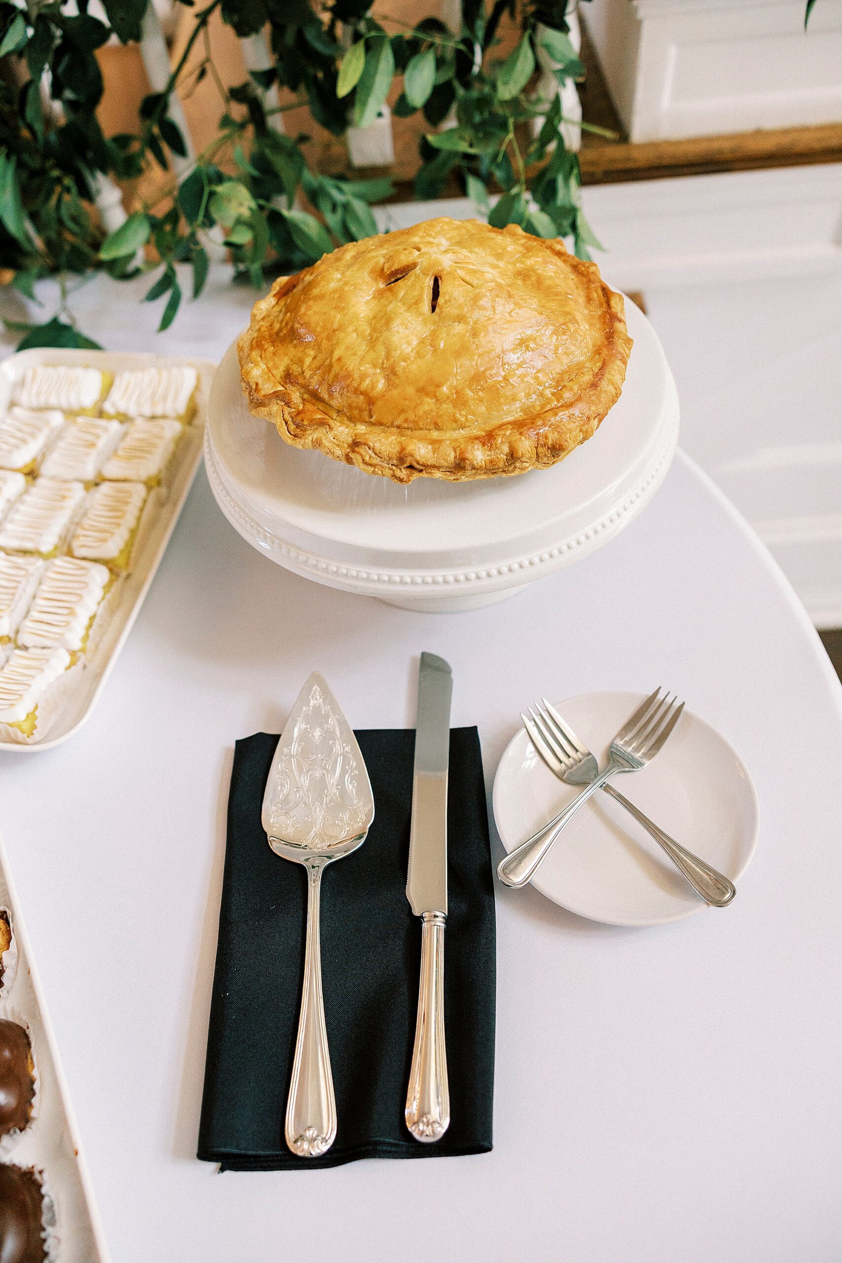 pie with serving utensils for reception 