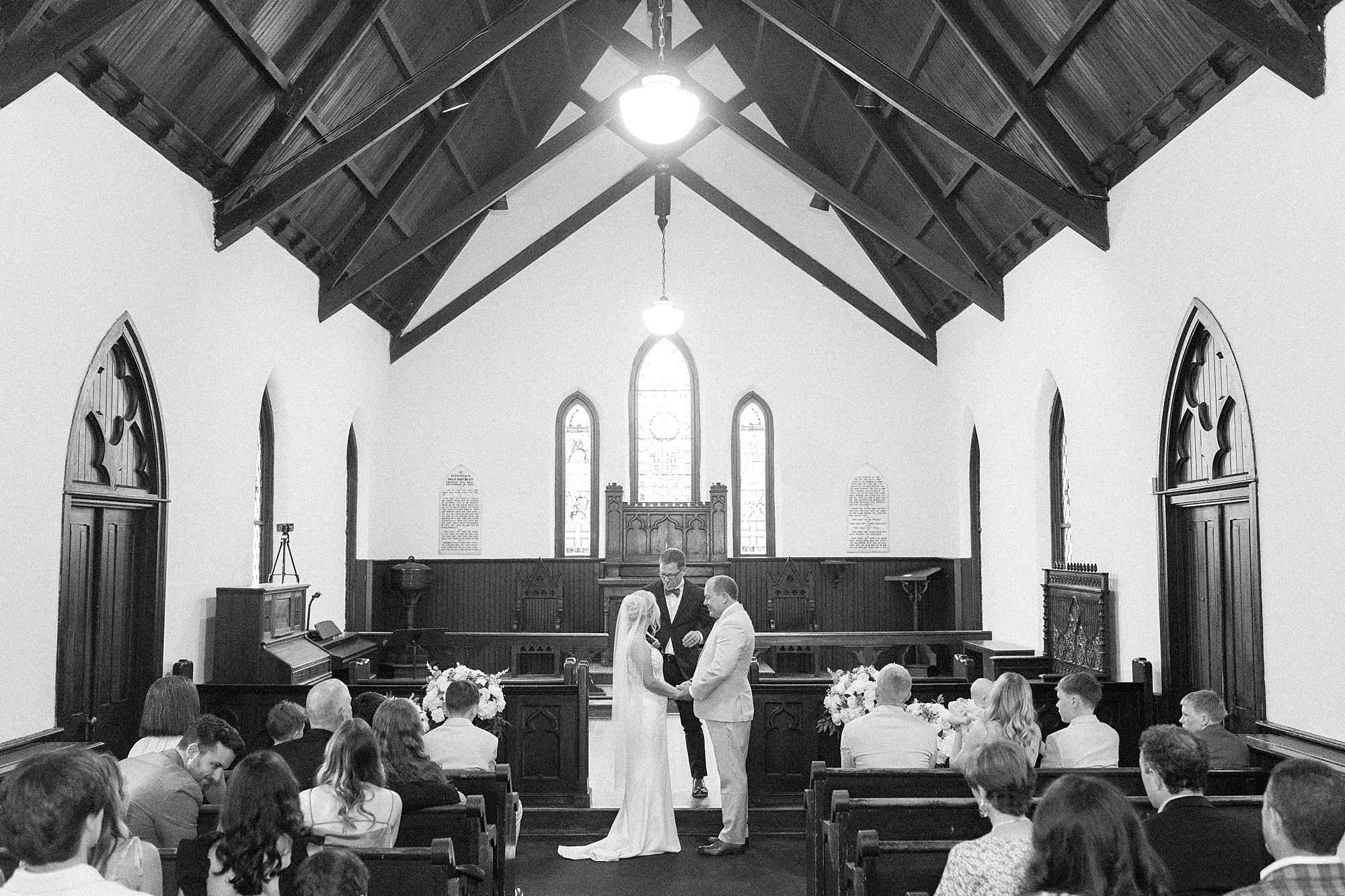 bride and groom hold hands during intimate ceremony at St. Mary's Chapel