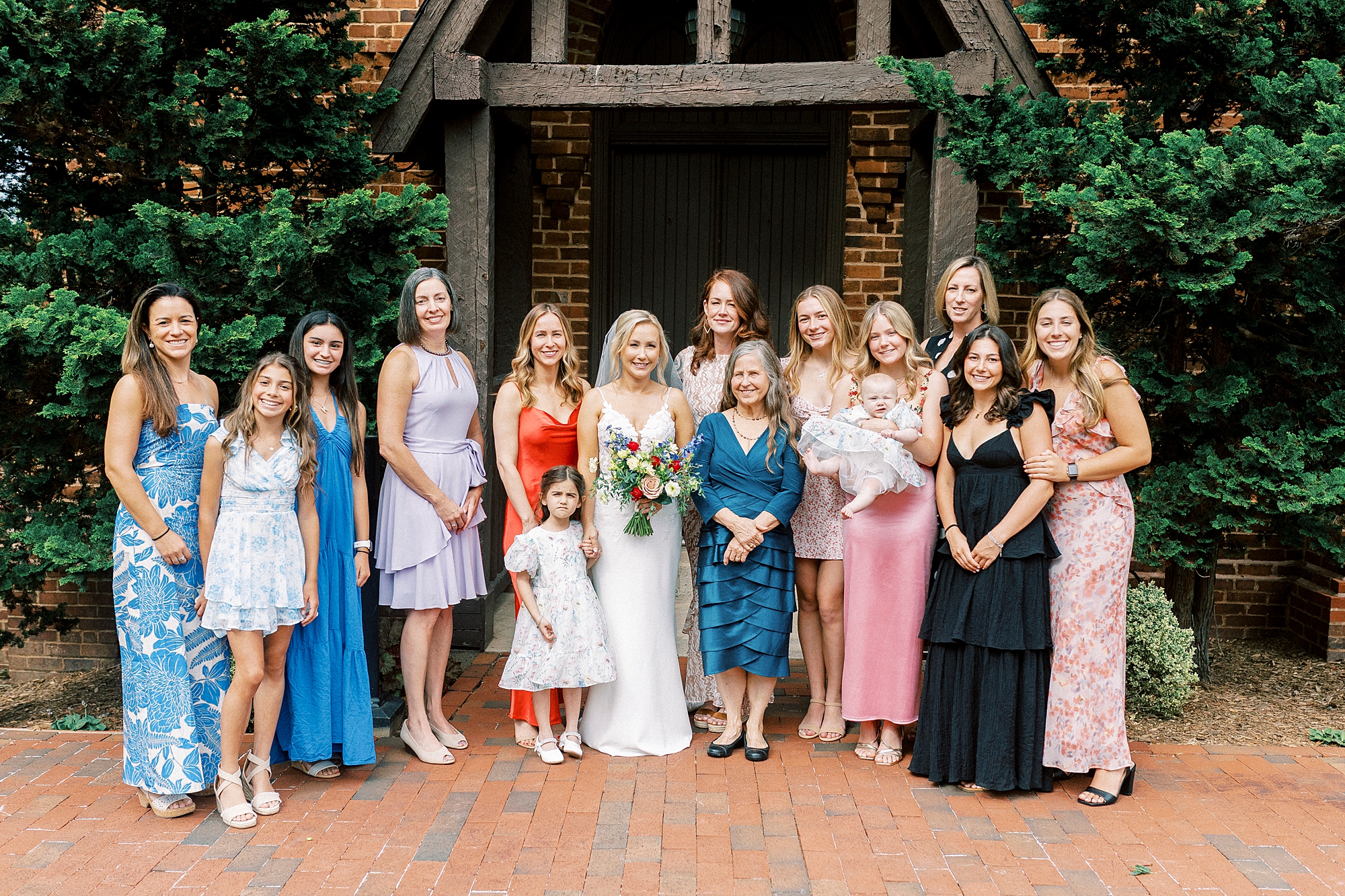 bride poses with female guests at wedding