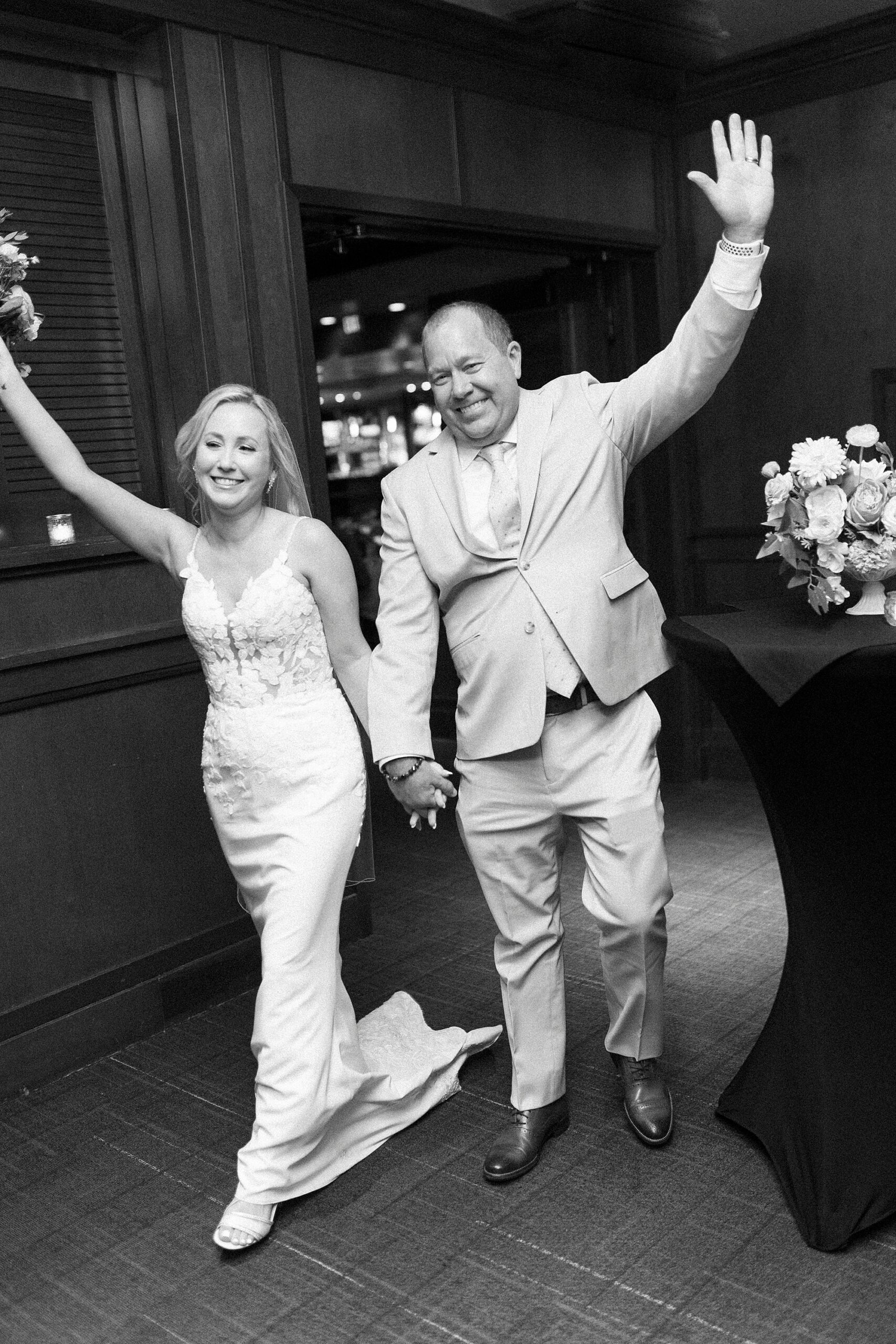 newlyweds cheer entering reception at Fleming's Steakhouse