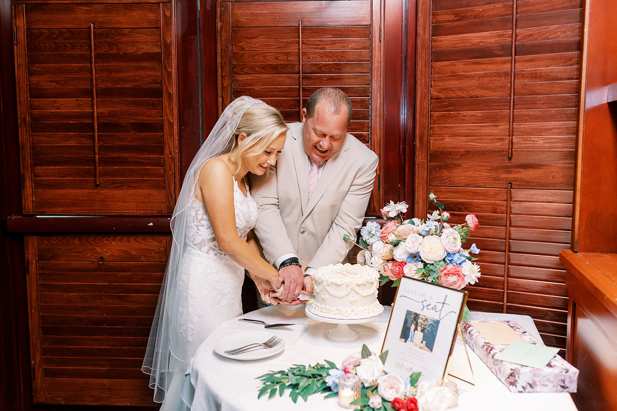 bride and groom cut wedding cake inside Fleming's Steakhouse 