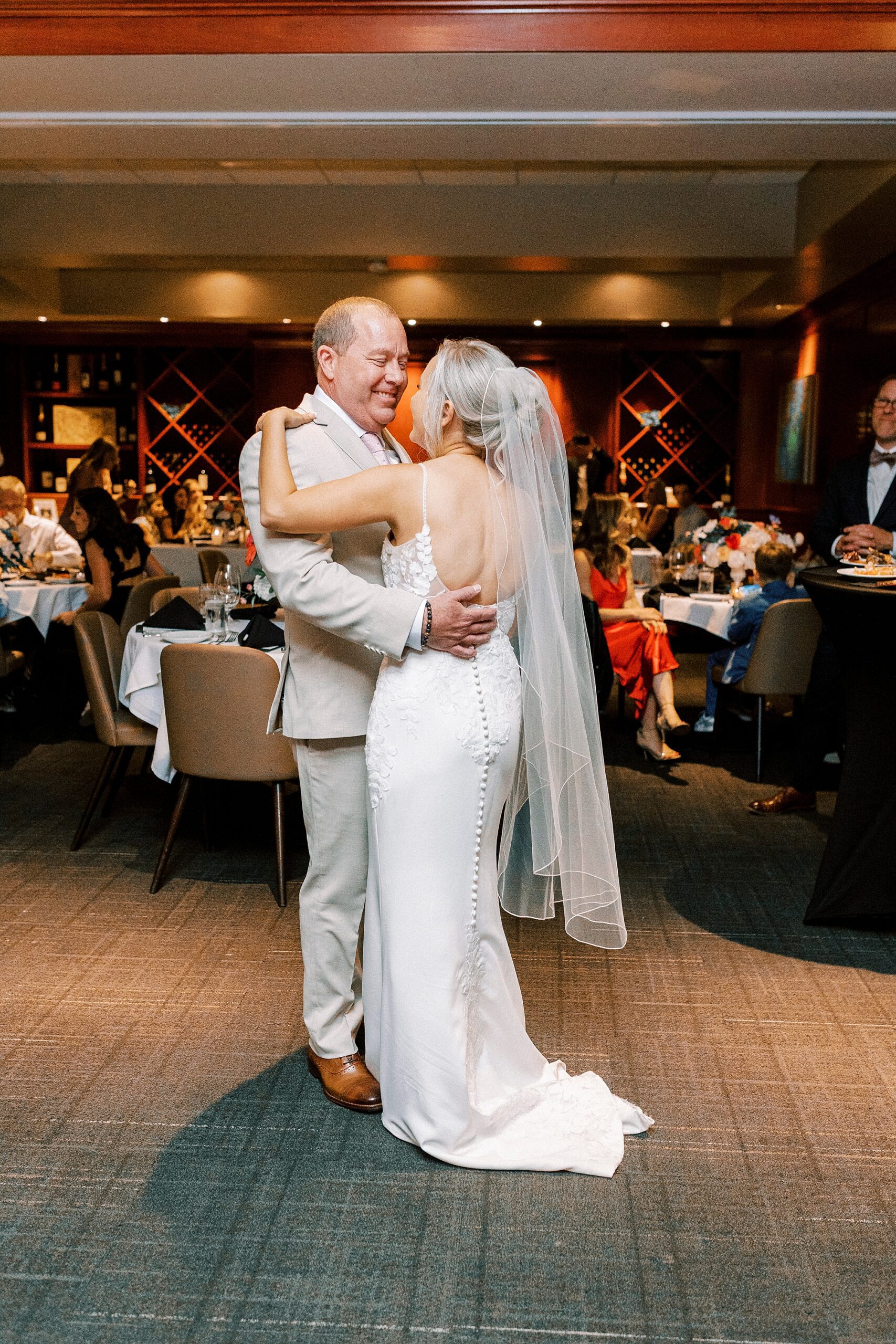 bride and groom dance during reception at Fleming's Steakhouse 