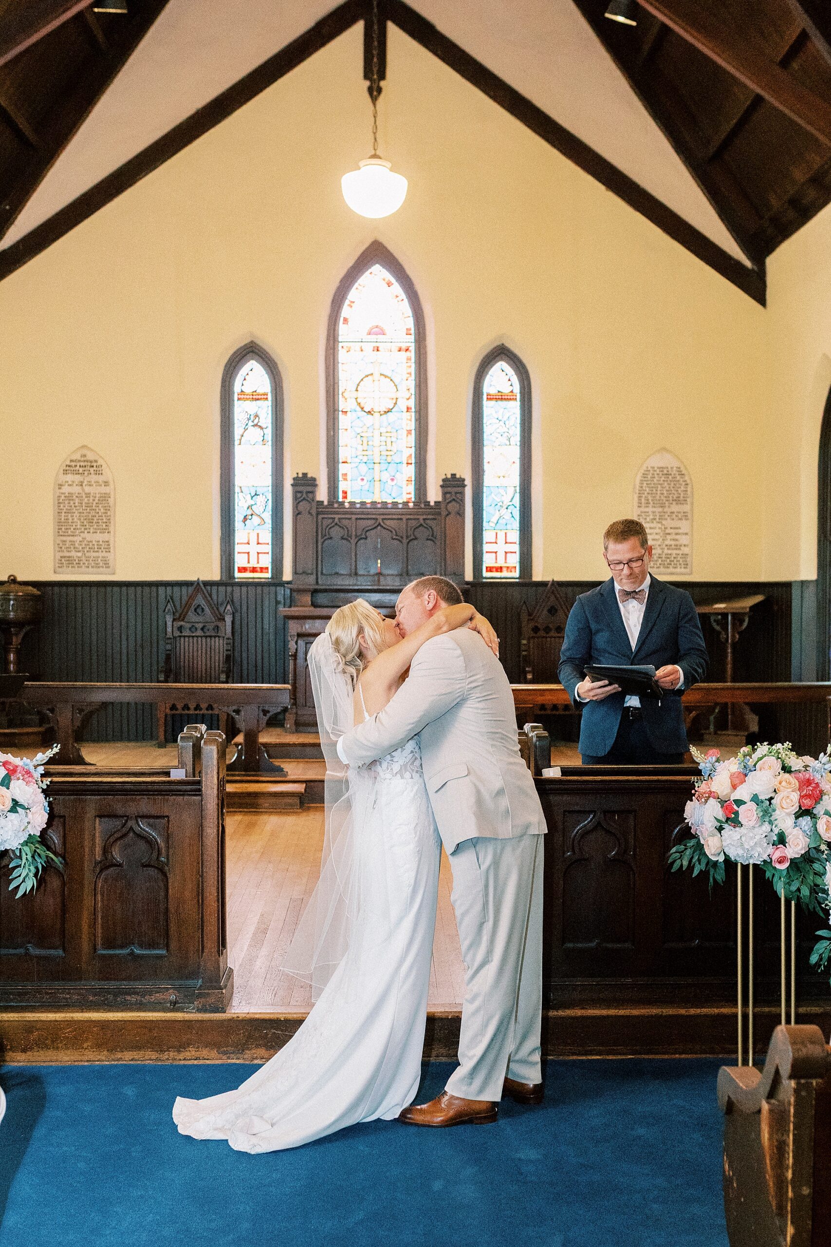 bride and groom kiss after ceremony inside St. Mary's Chapel
