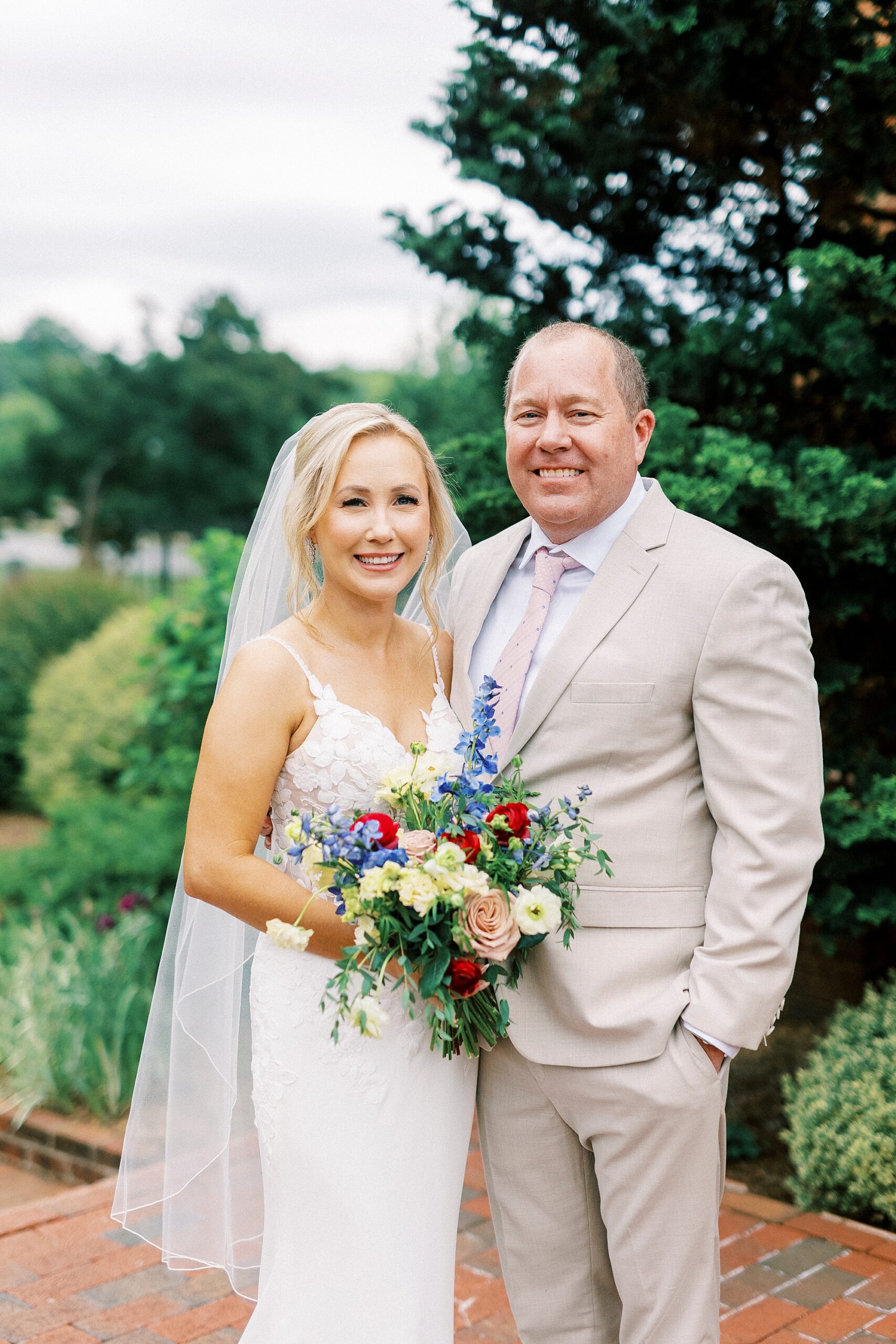 bride and groom smile together outside chapel 