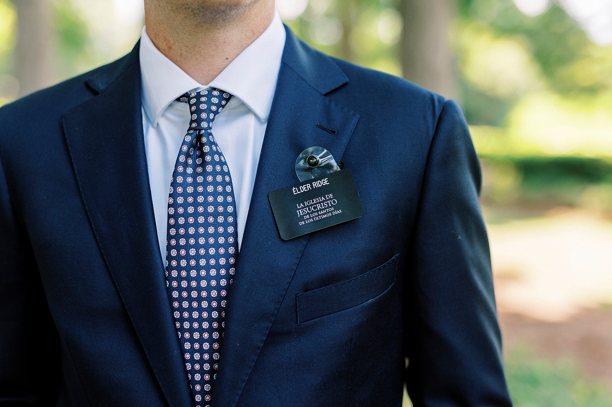 closeup of LDS name tag on man's blue suit lapel