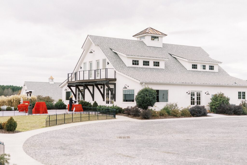 outdoor view of large white barn at chickadee hill wedding venue in Statesville North Carolina