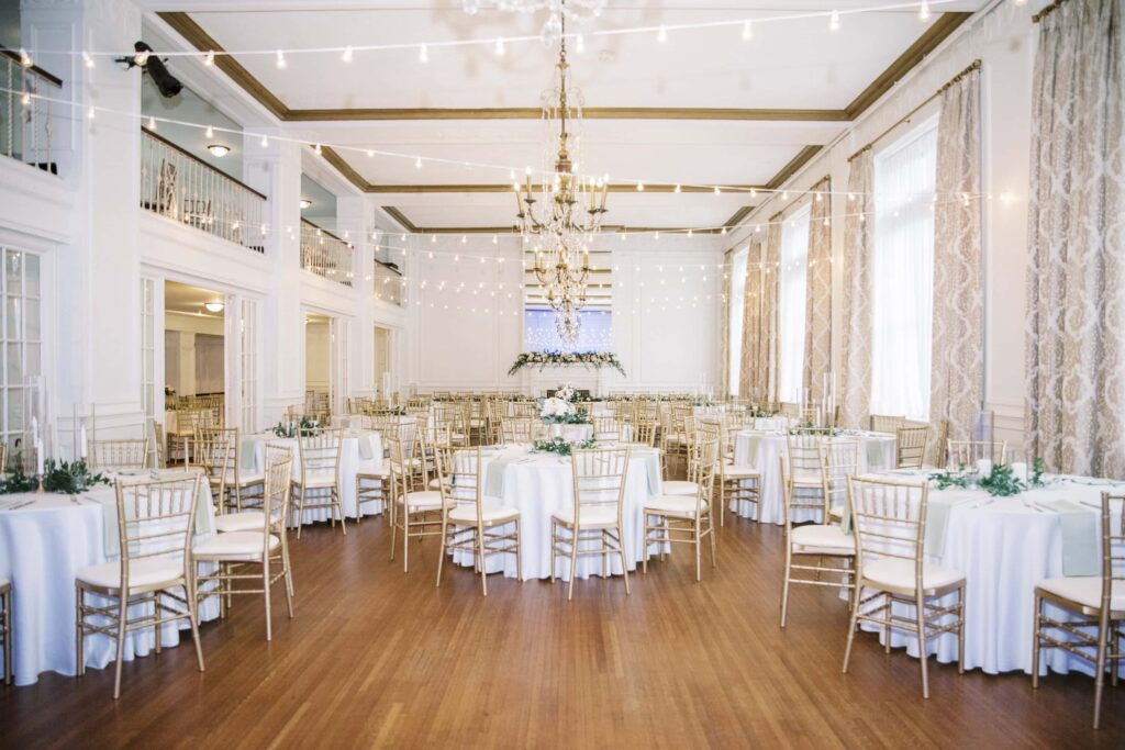 indoor wedding reception tables and decor with string lights inside the hotel concord in concord North Carolina