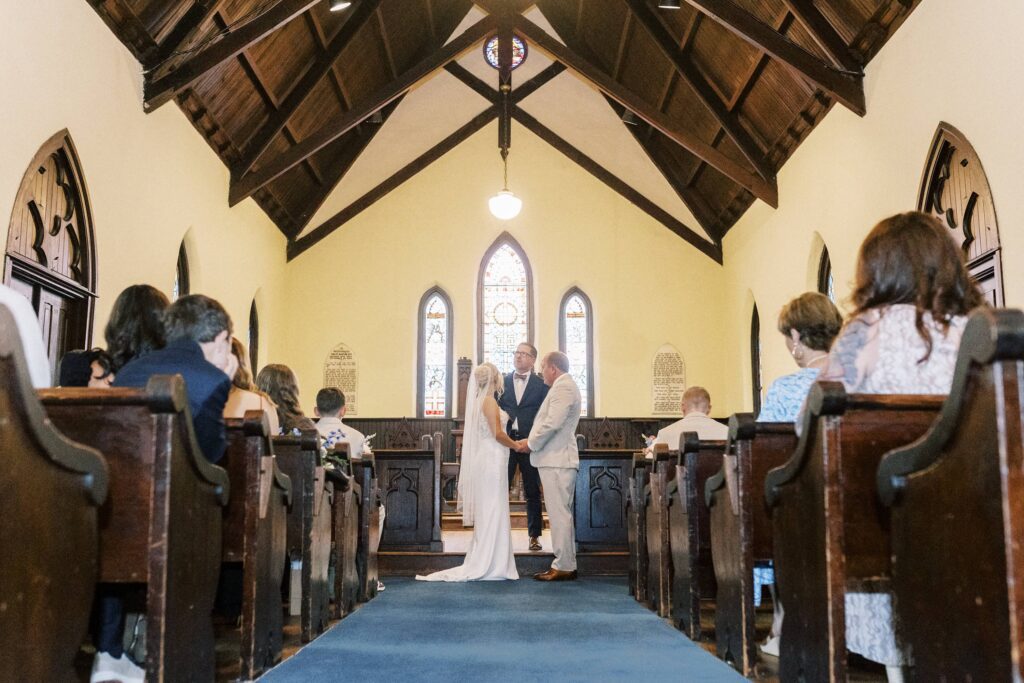bride and groom getting married inside st Mary's wedding chapel in Charlotte 