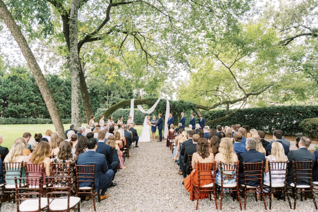 outdoor wedding ceremony under large tree branch at whitehead manor in Charlotte 