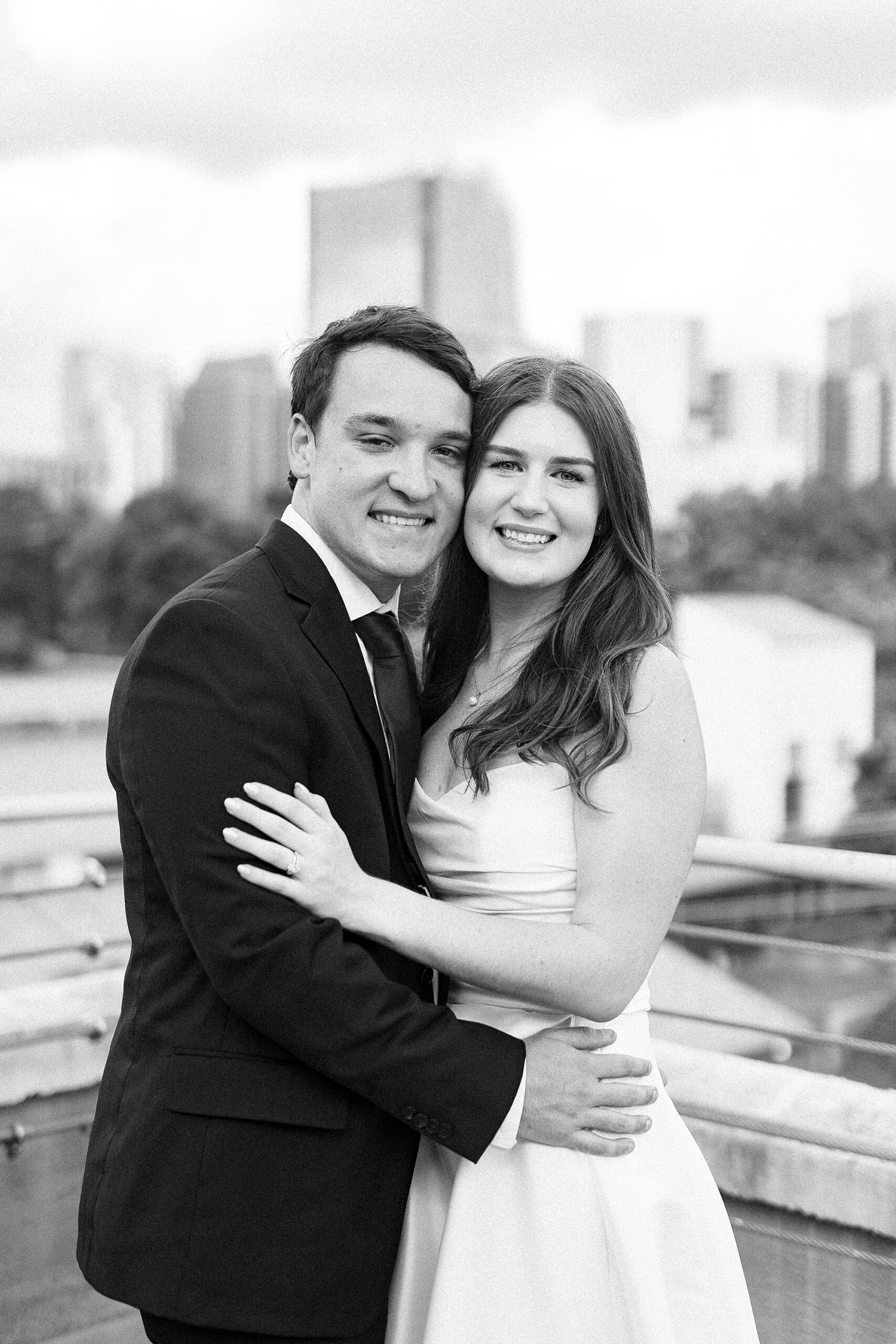 man and woman hug in corner of patio at the Terrace at Cedar Hill