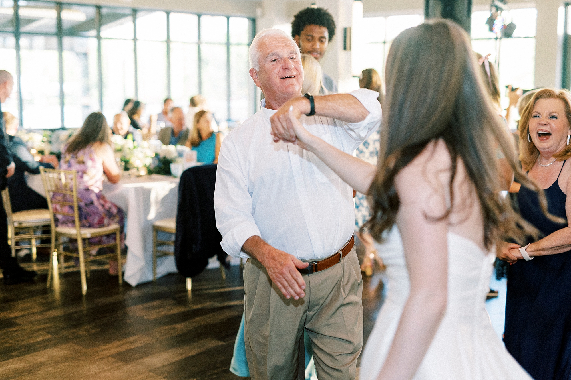 man twirls bride during dances at reception in Charlotte NC