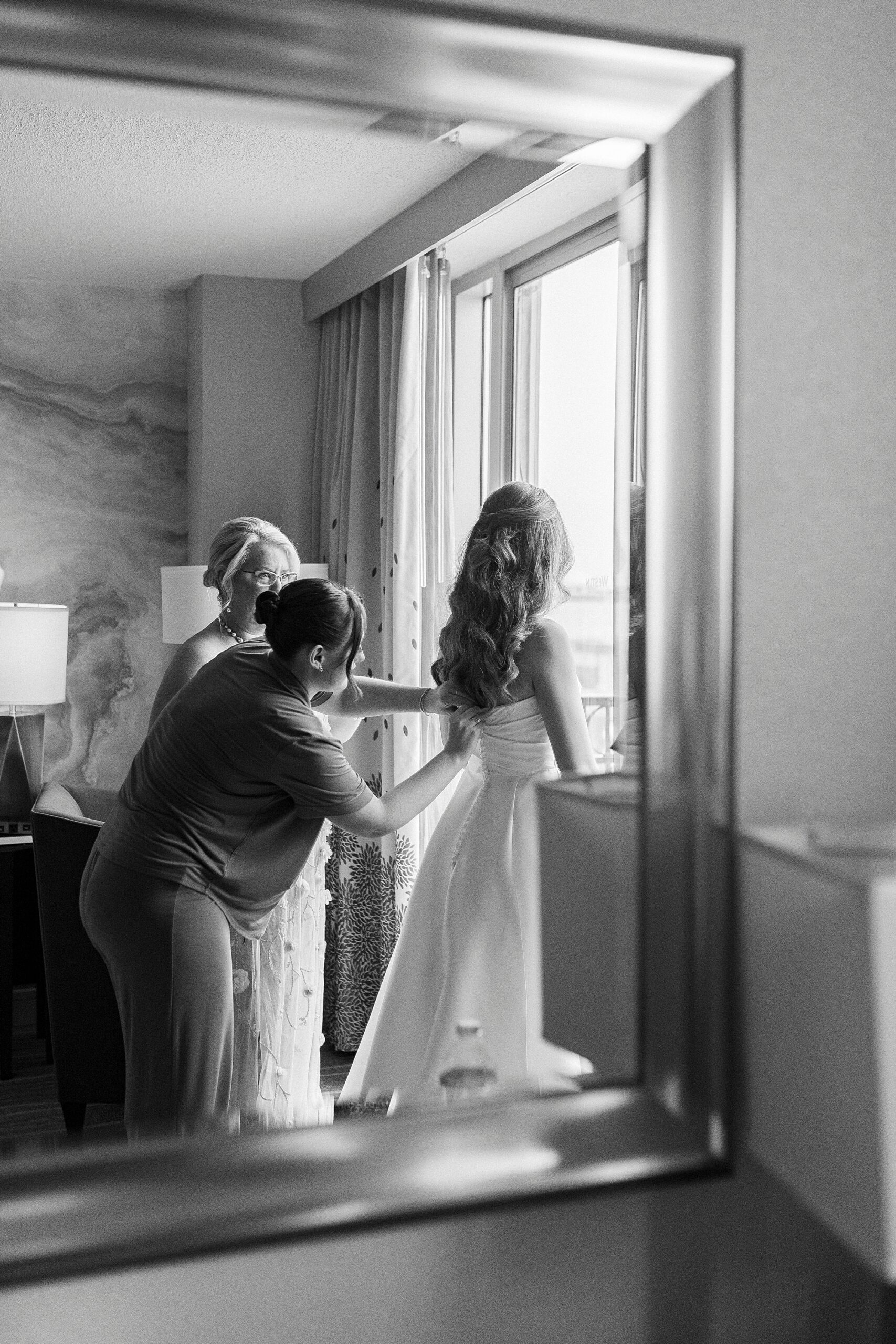 bride getting into wedding dress