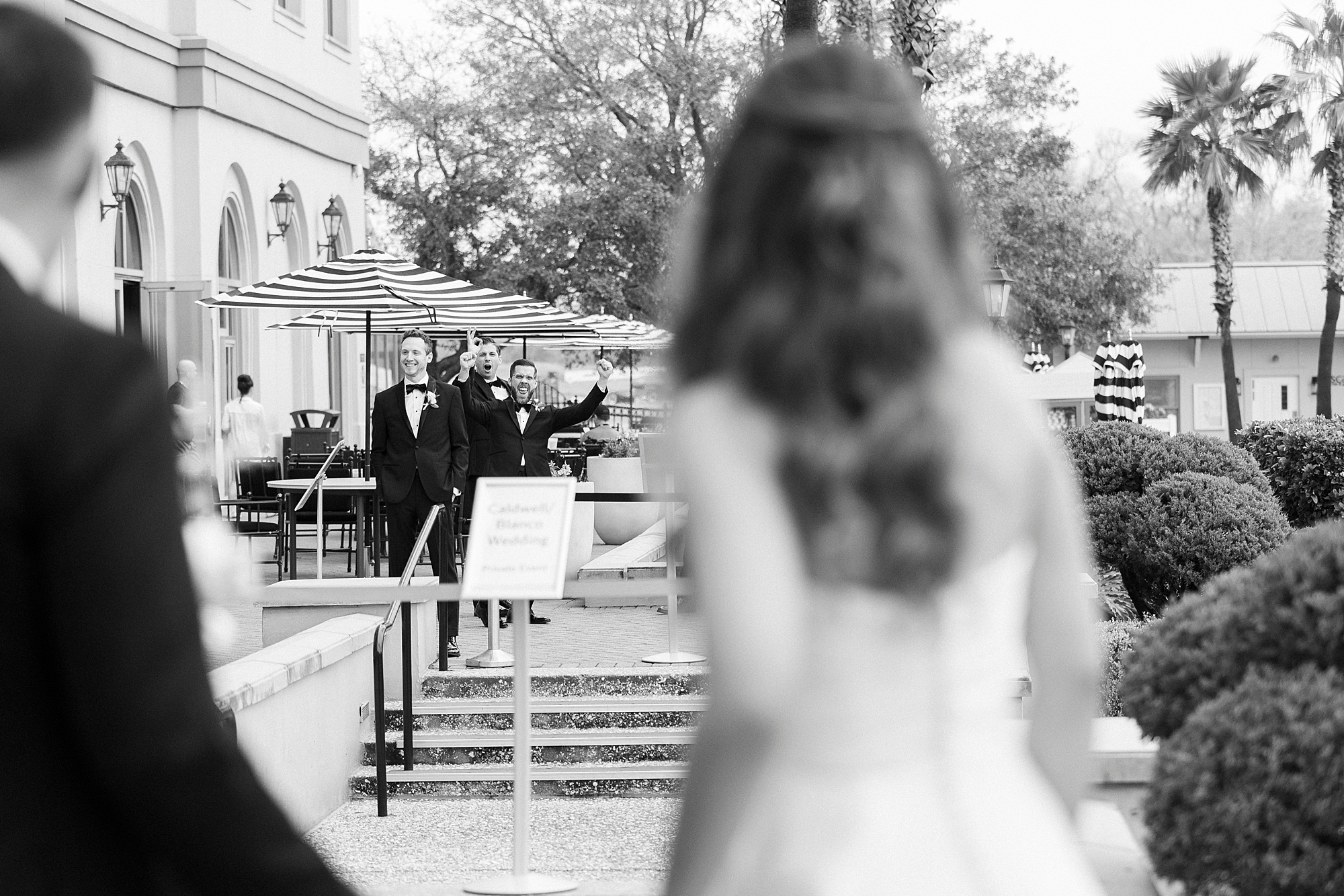 groomsmen cheer at bride and groom