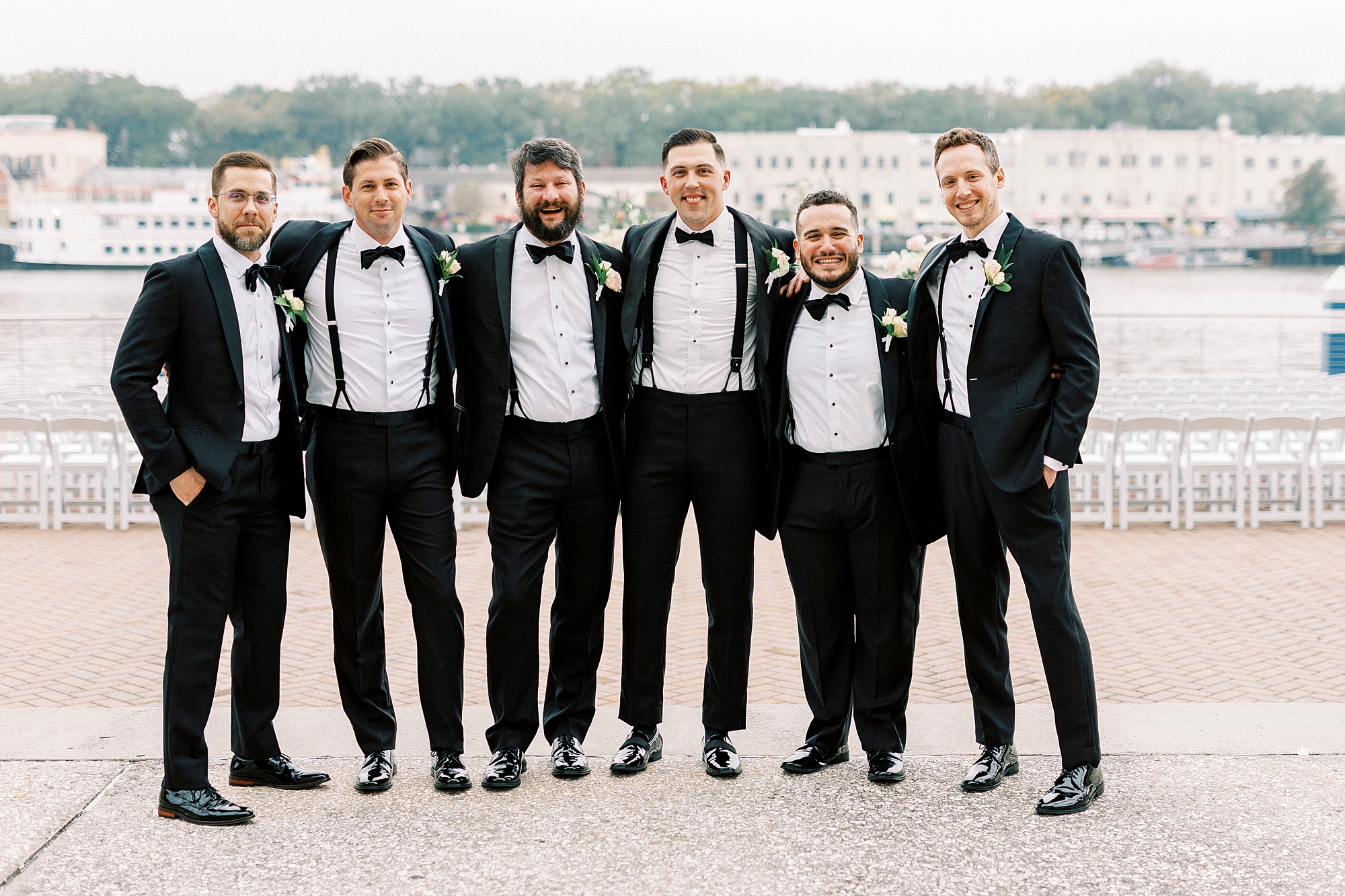 groom and groomsmen by the water