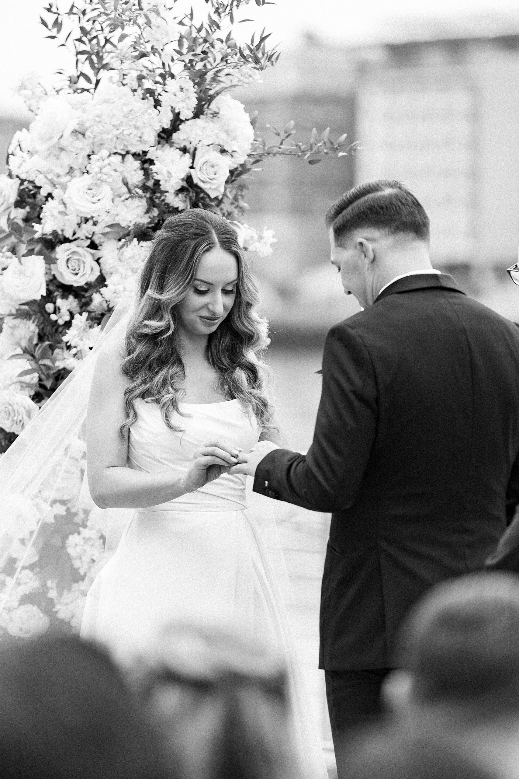 bride and groom exchange wedding rings