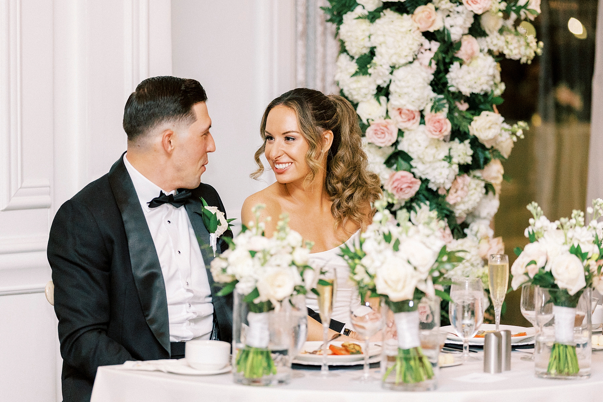 newlyweds sit together at dinner