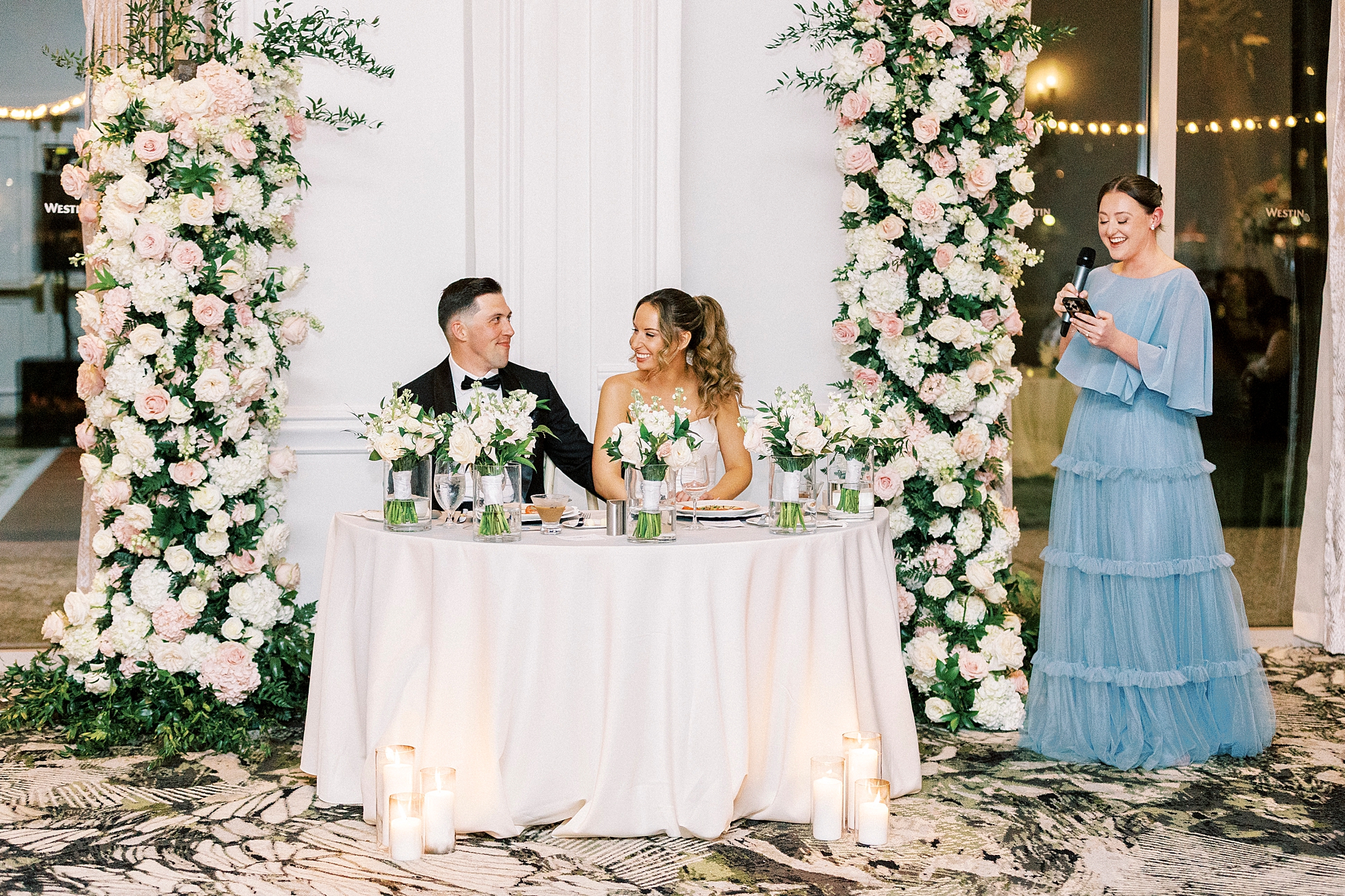 newlyweds listening to wedding speeches