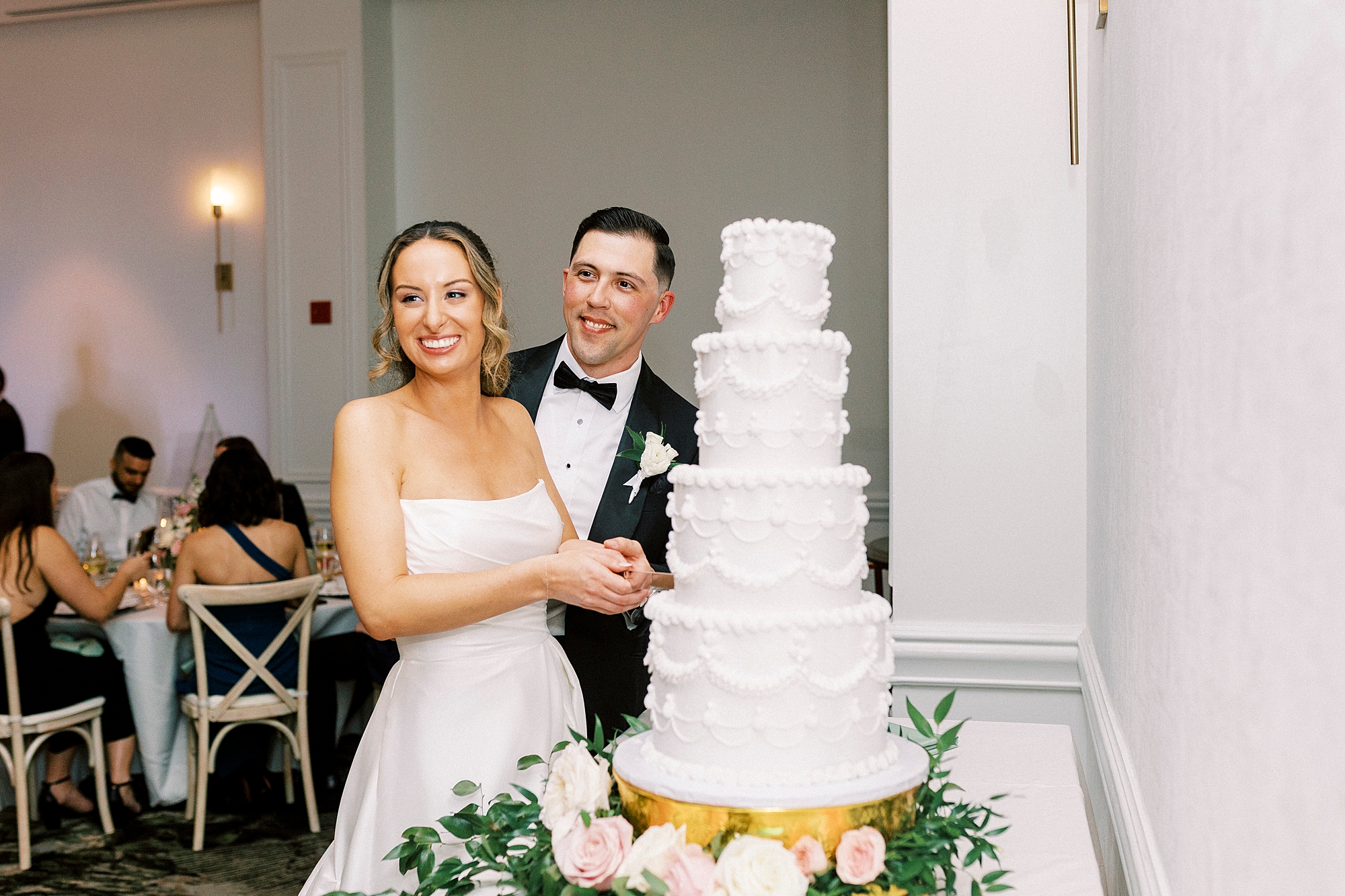 bride and groom cut wedding cake 