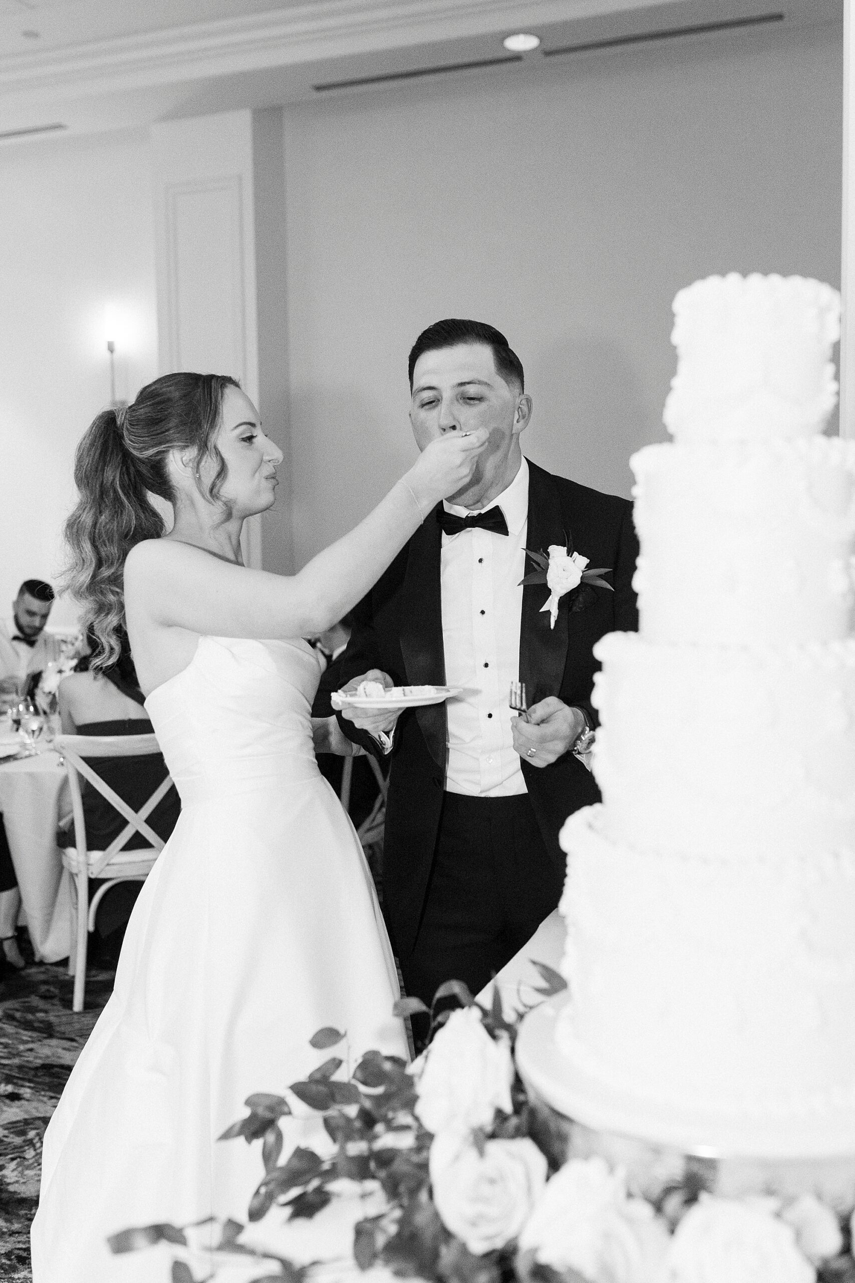 bride feeds groom wedding cake