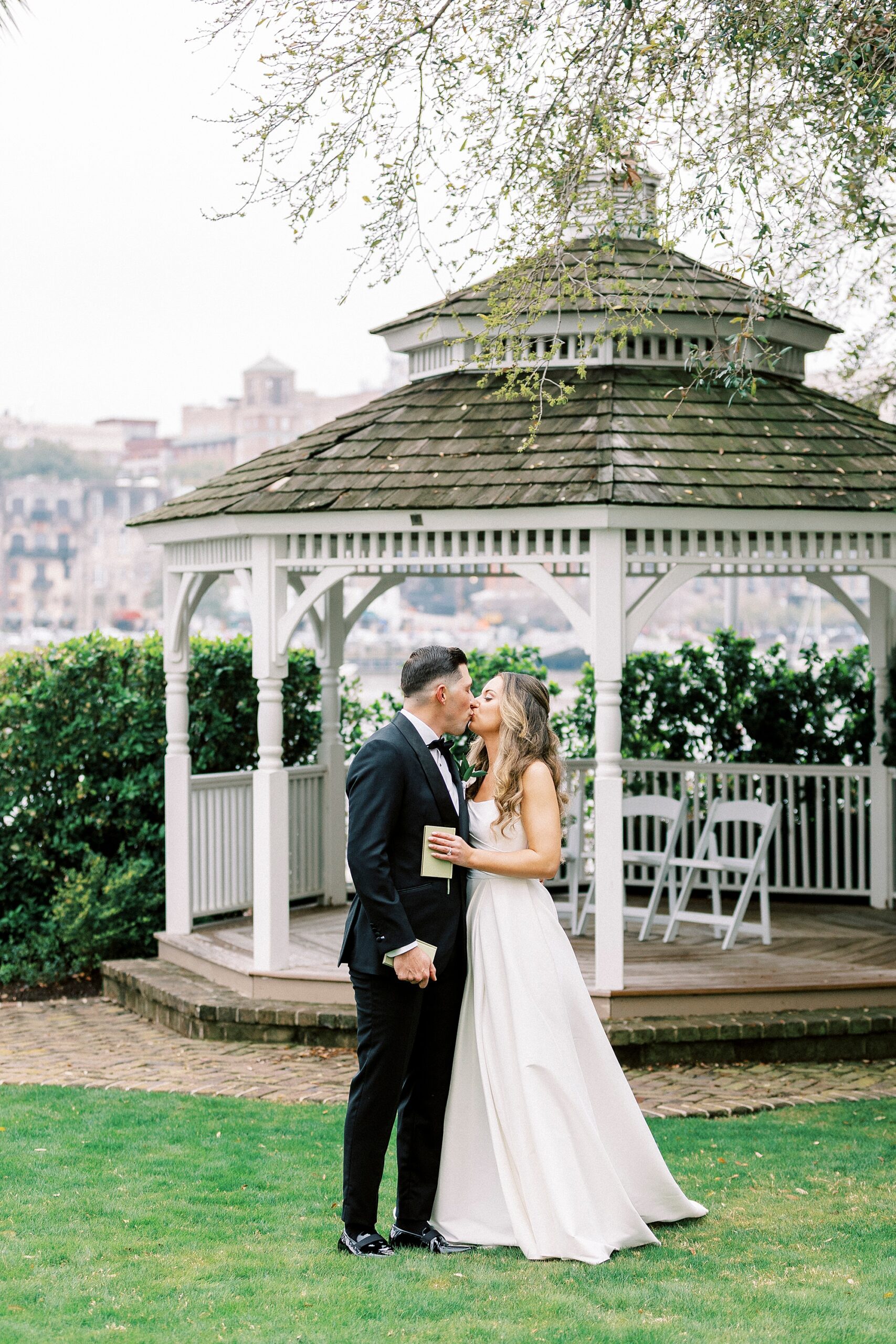 bride and groom kiss by gazebo at Waterfront Wedding at The Westin Savannah