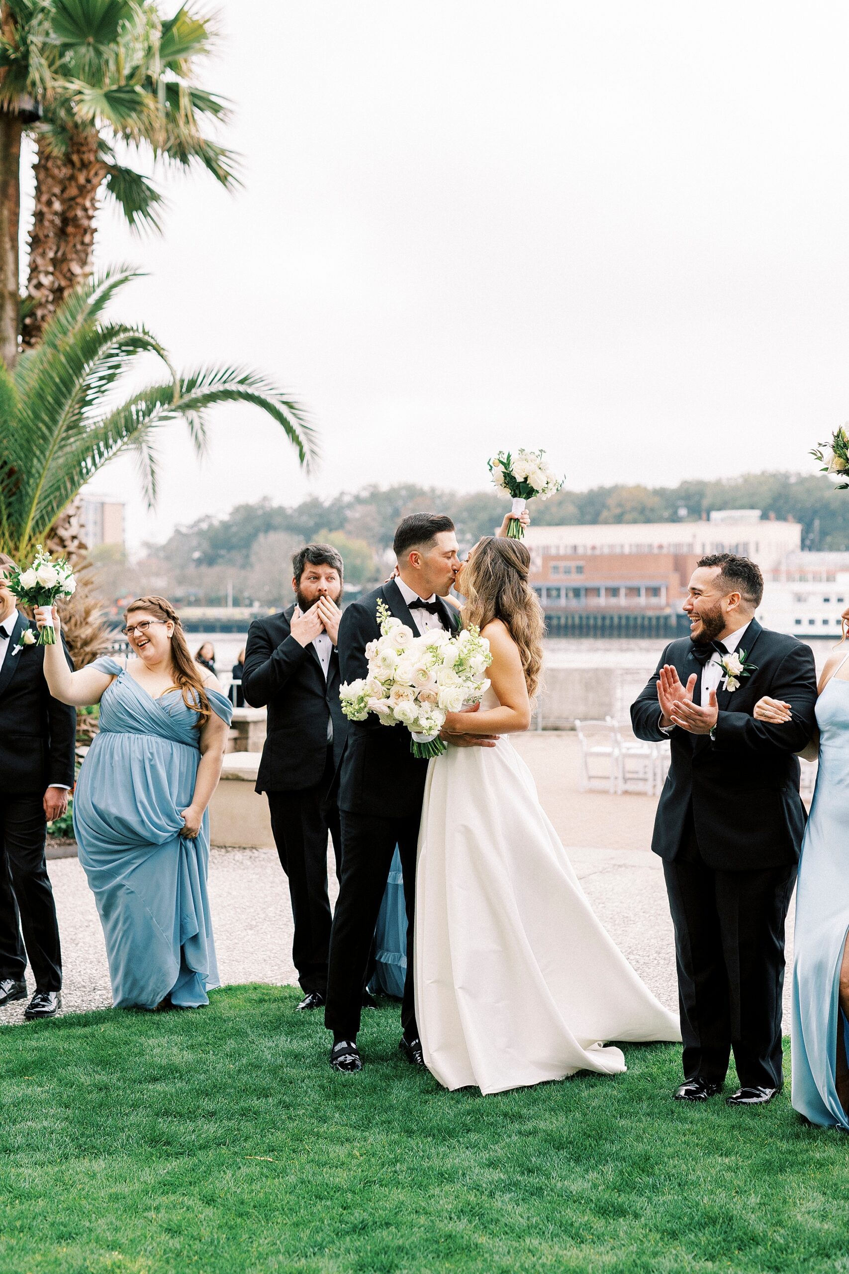 bride and groom kiss at waterfront wedding ceremony 