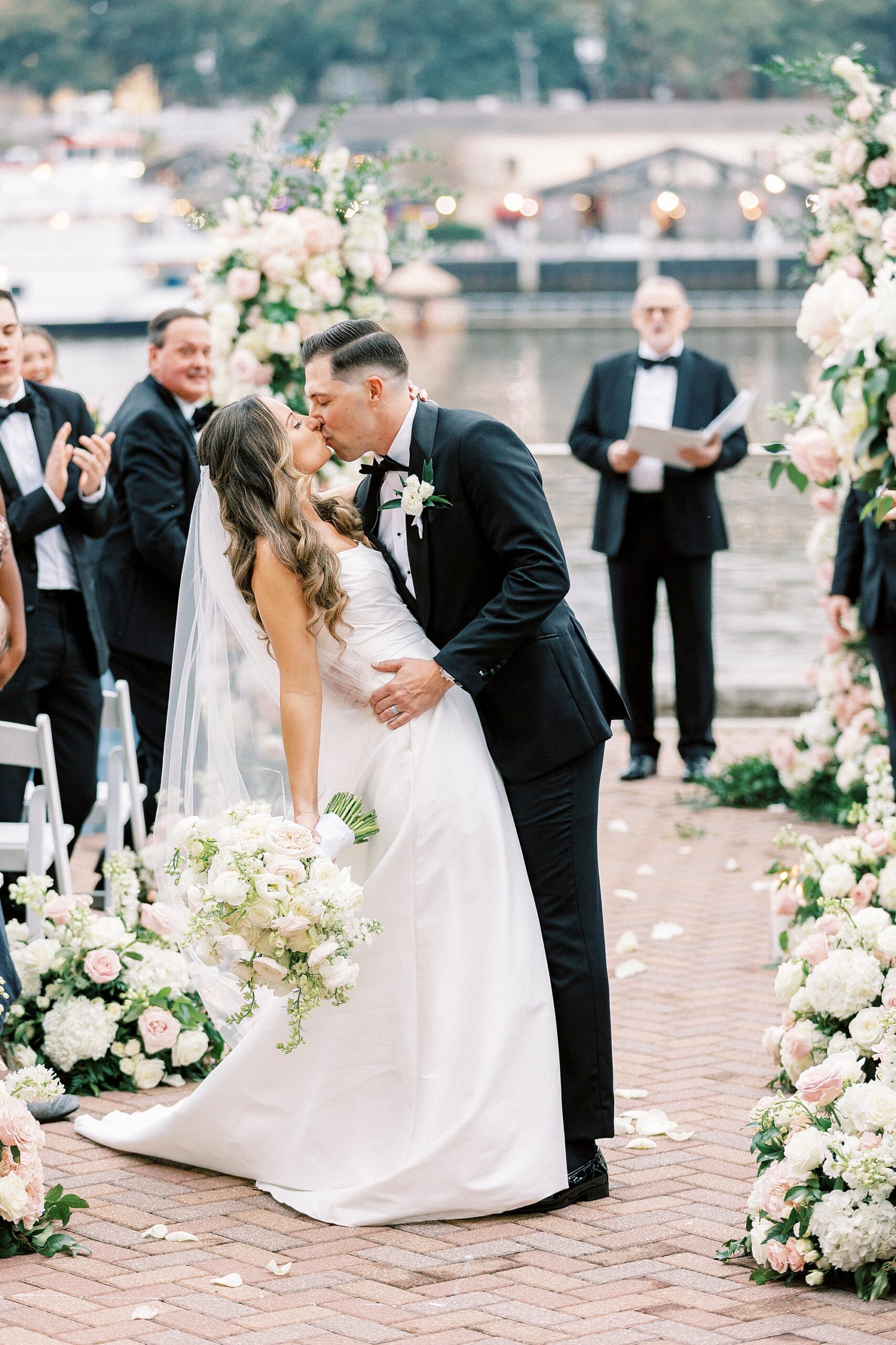 newlyweds kiss as they exit wedding ceremony on the water 