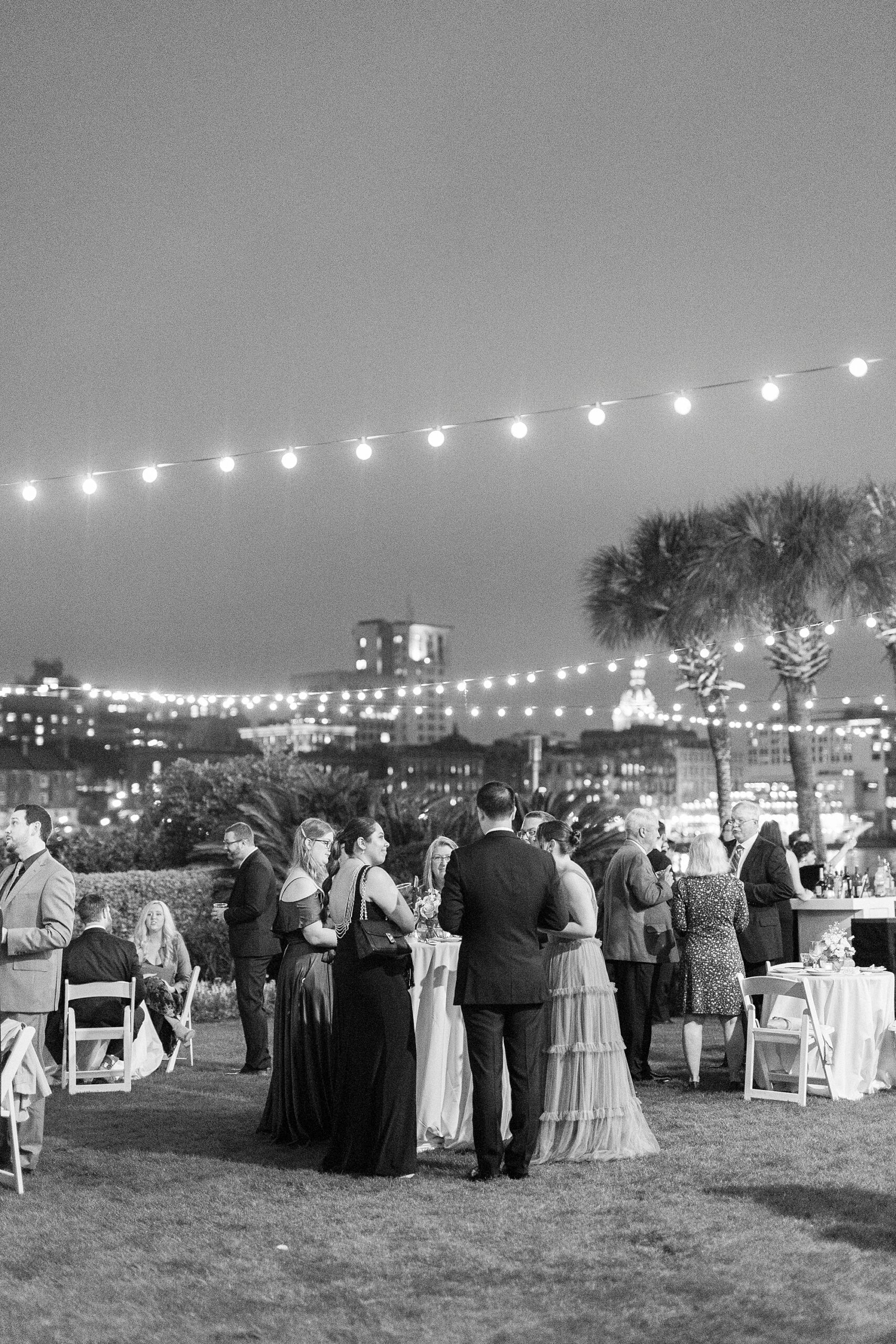 wedding guests mingle outside on the lawn 