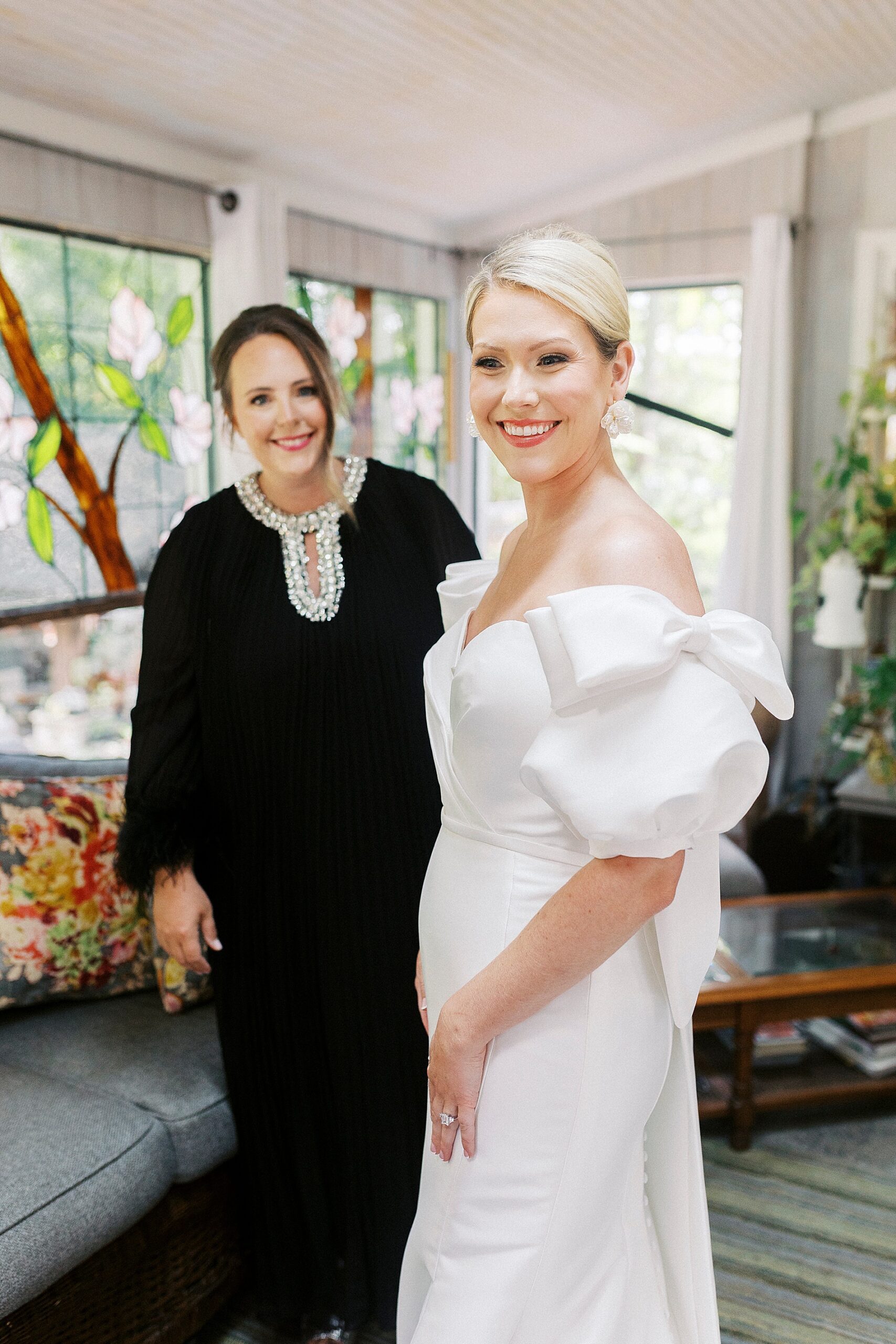 bride in wedding dress with white bows on sleeves