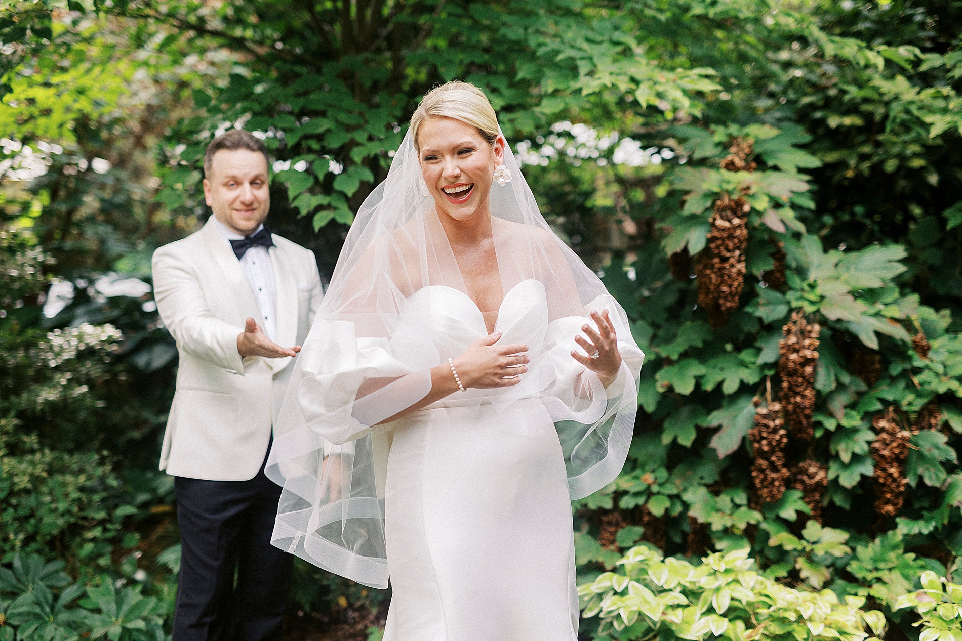 groom admires bride in wedding dress