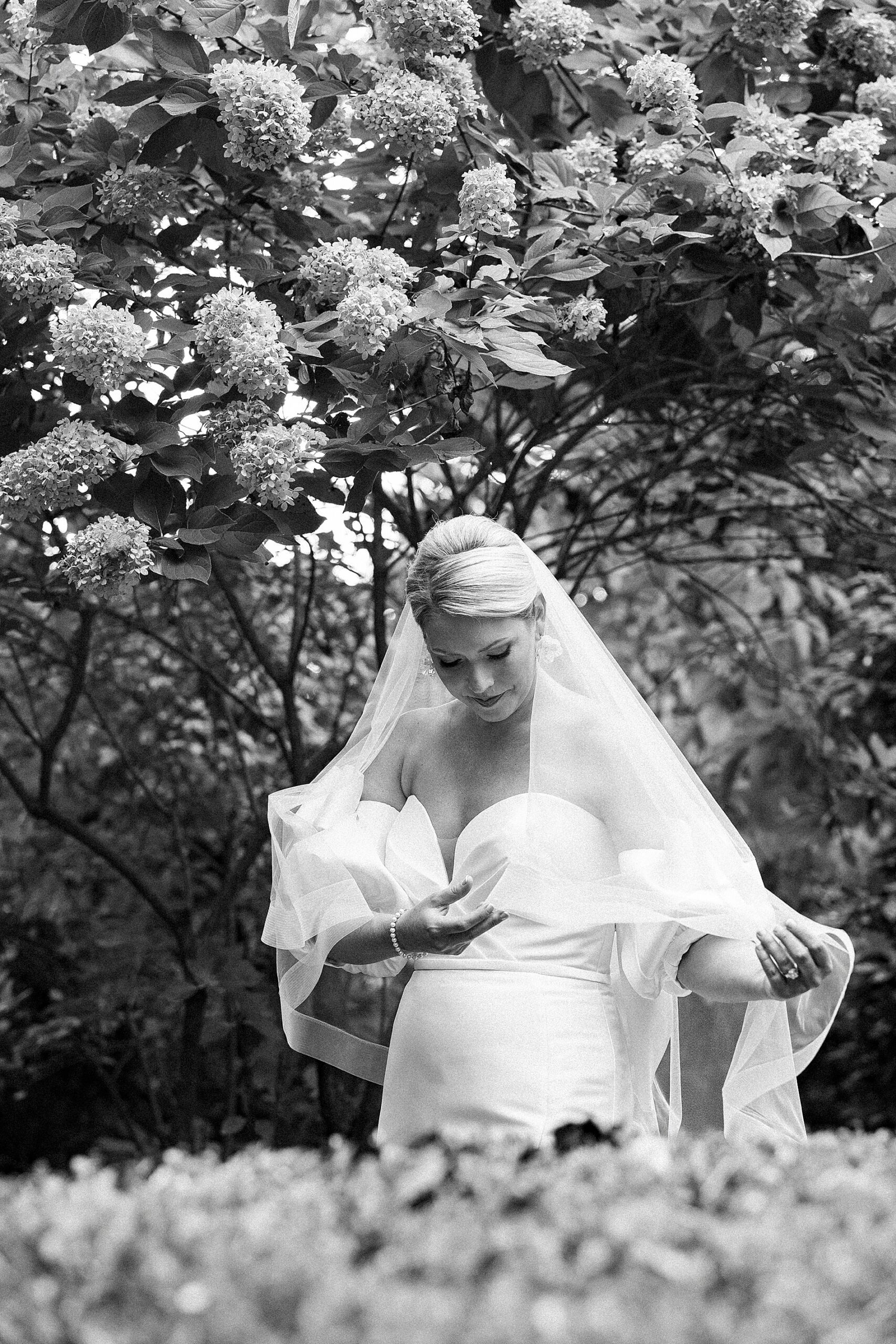 bride looking at veil