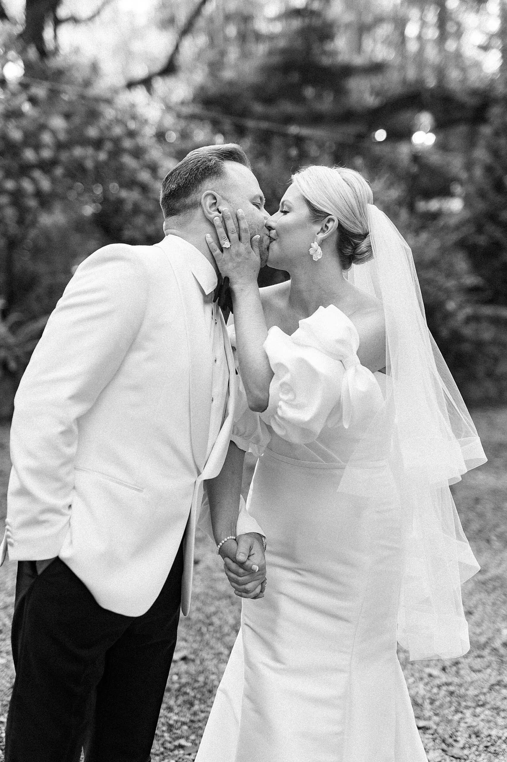 timeless wedding photos of bride and groom kissing