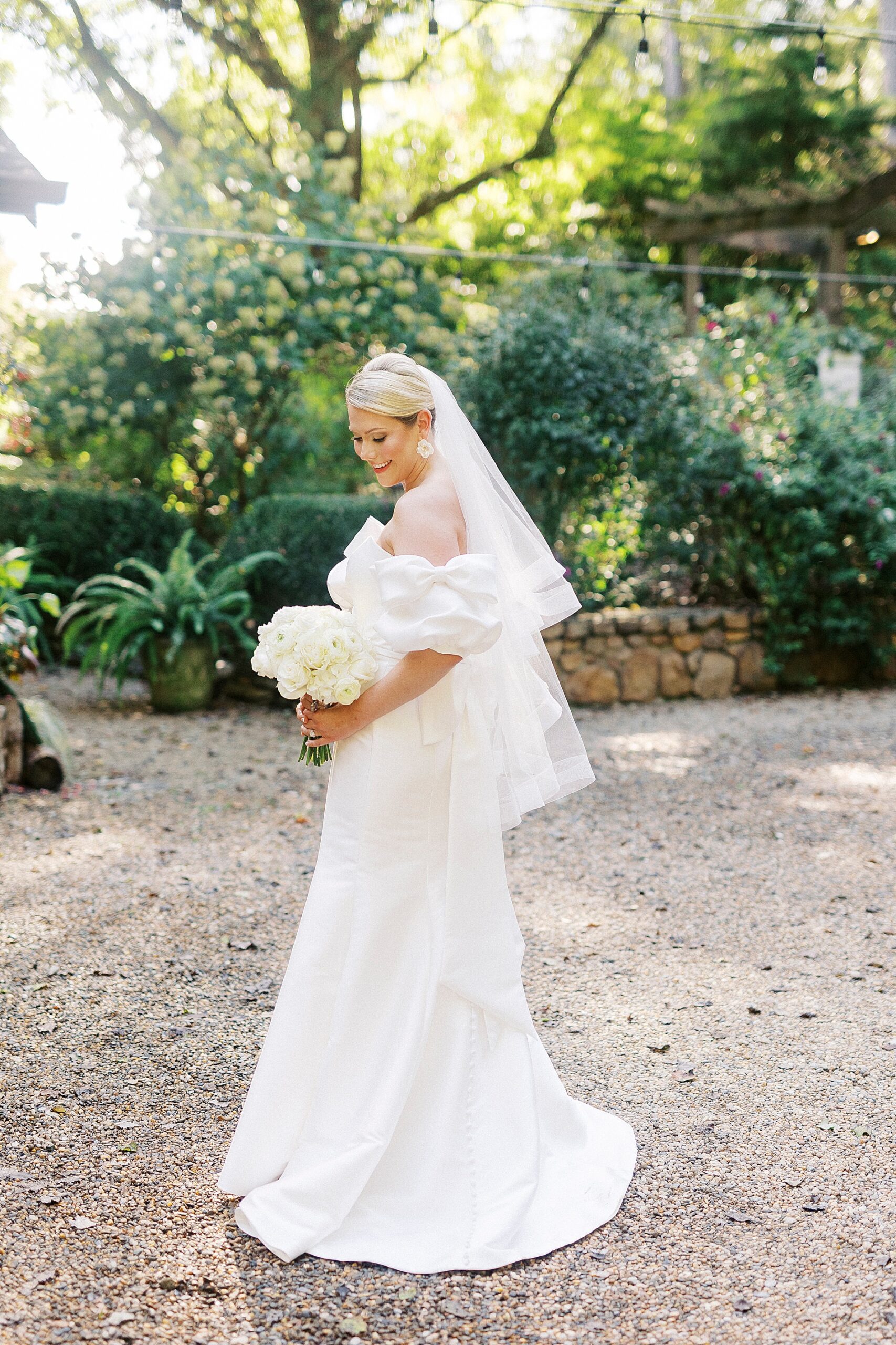 bride in dress holding white bridal bouquet