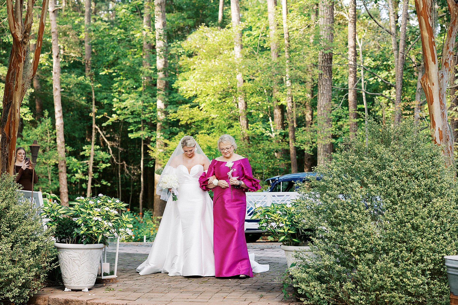 bride walking with mother down aisle