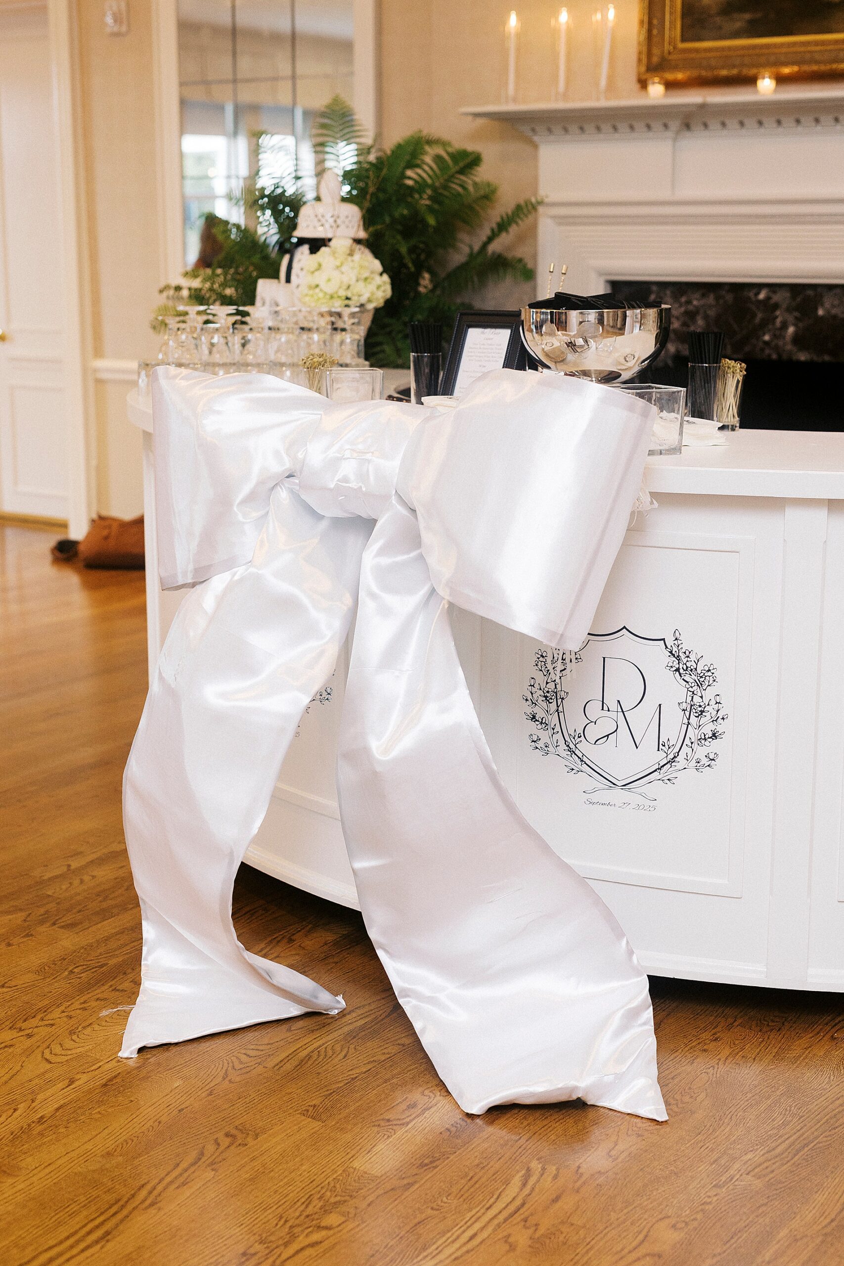 large bow on front of bar mirroring bow on bride's dress