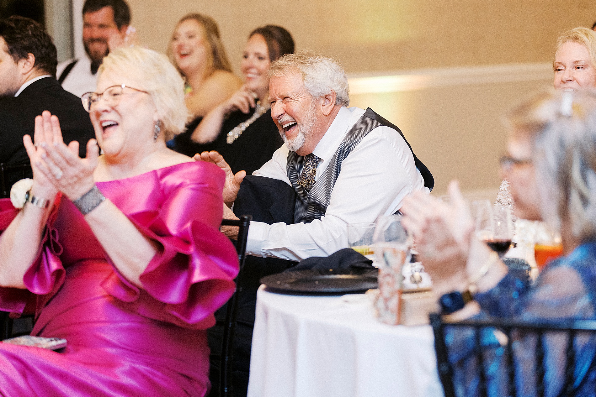 guests laugh during toasts