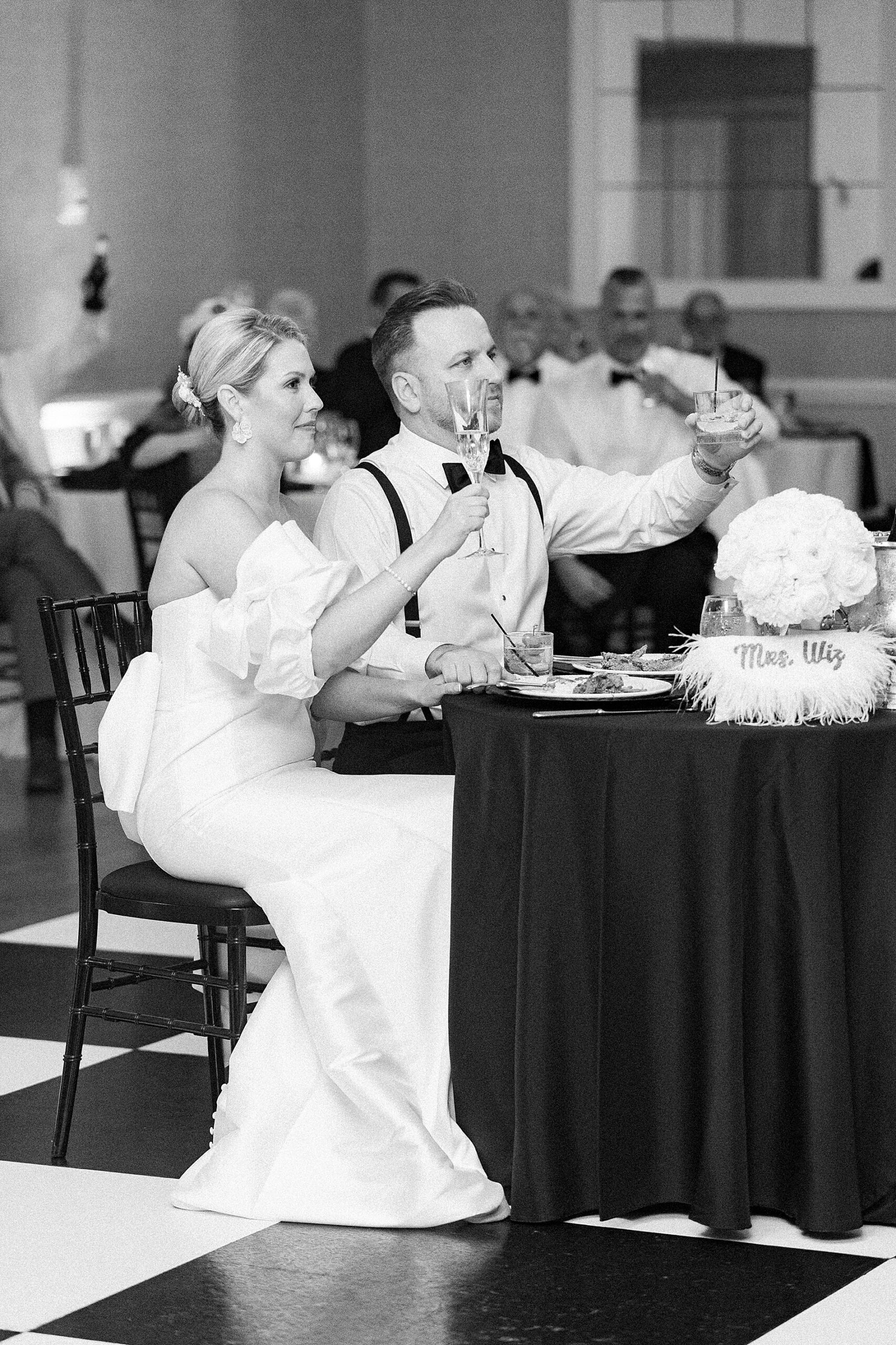 newlyweds raise their glass during toast