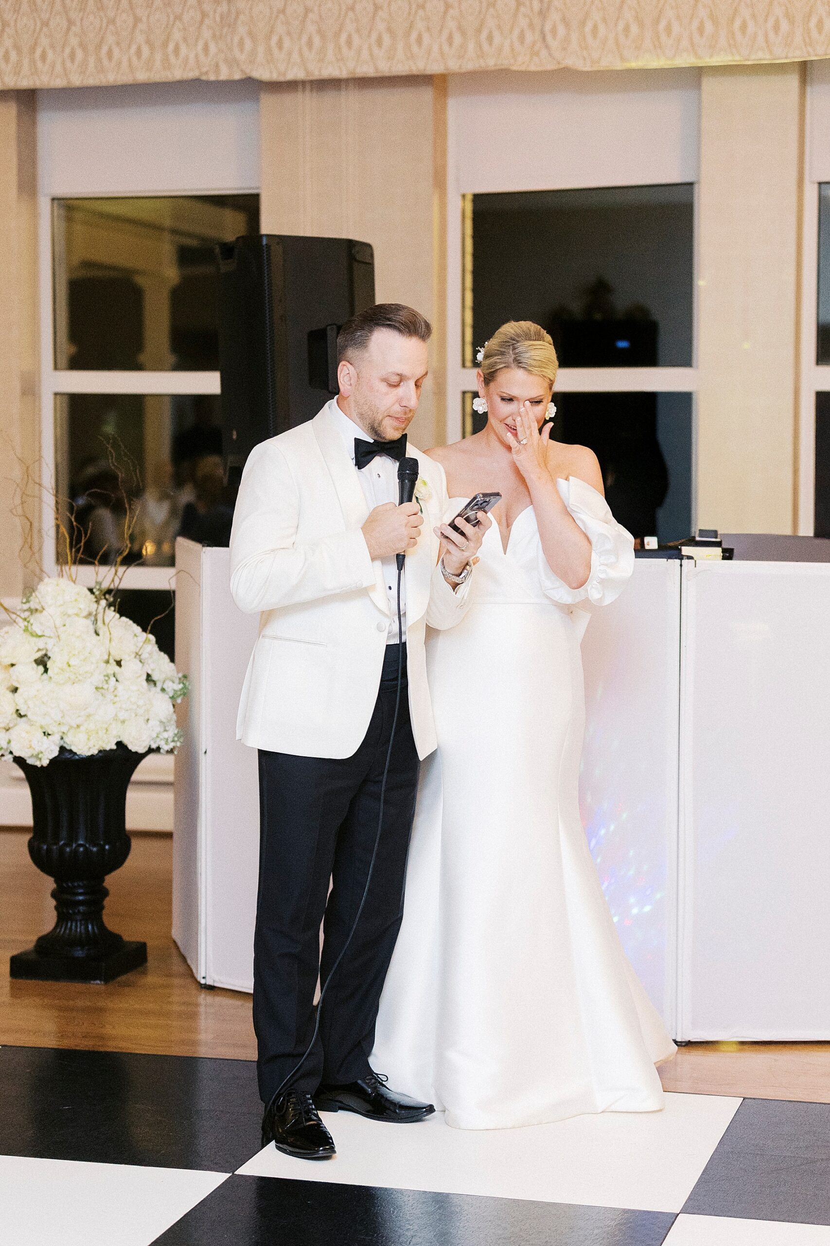 bride wipes away tears as her and groom deliver speech