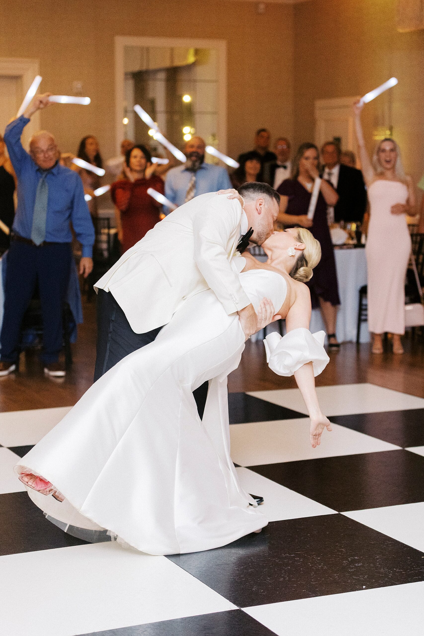groom kisses bride on dance floor