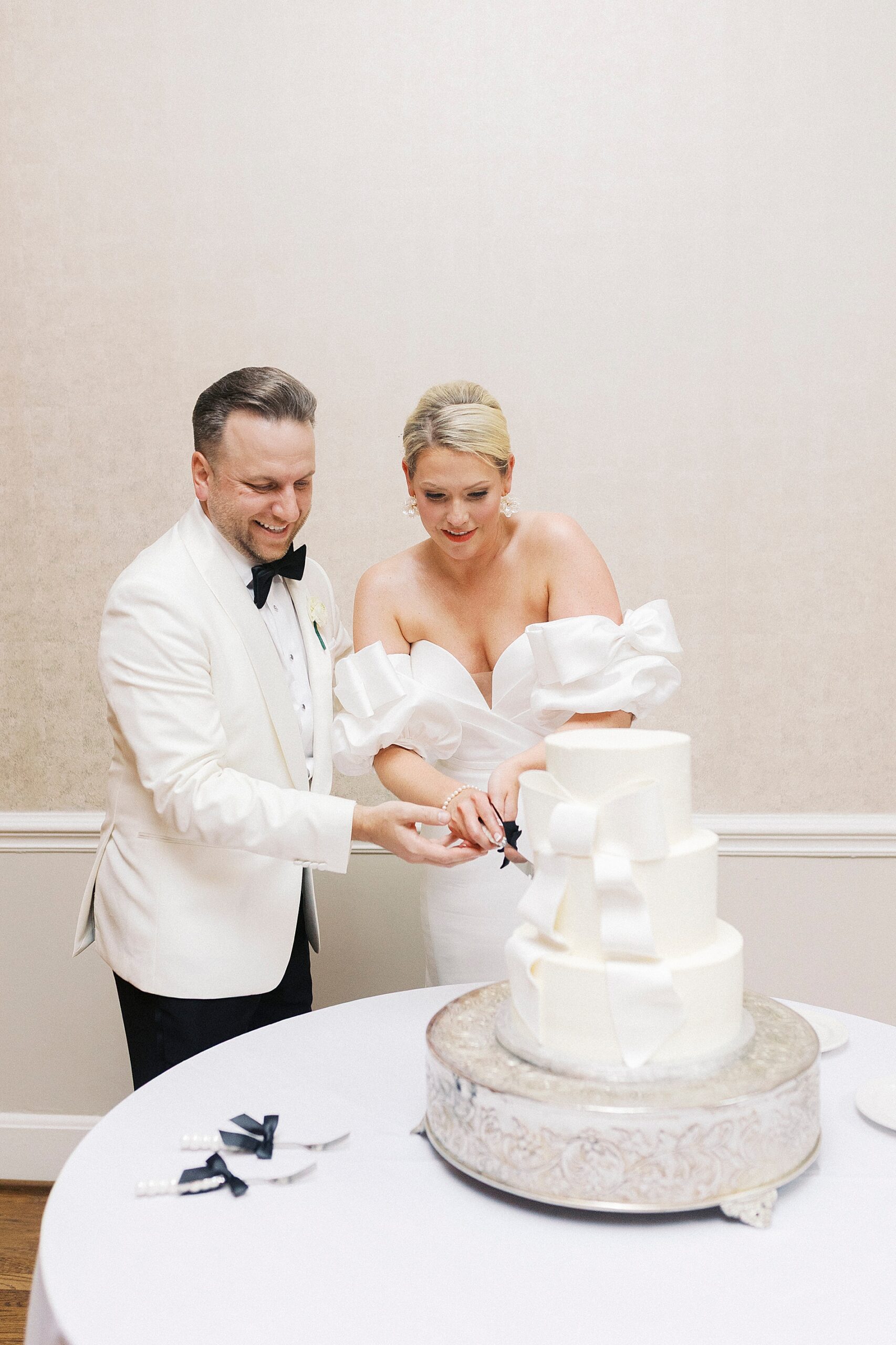 newlyweds cut cake at Gaston Country Club Wedding reception